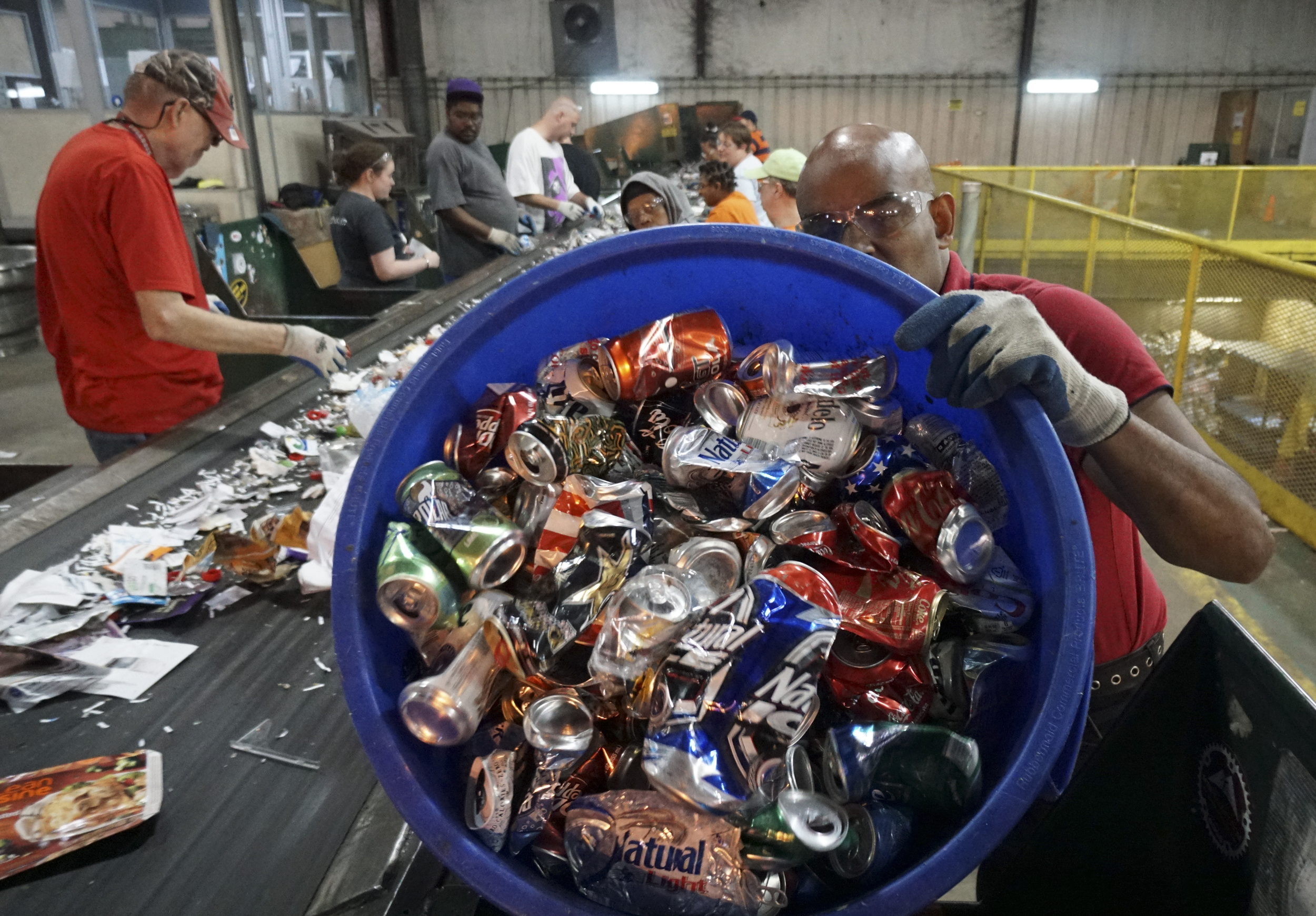 Staff Photo by Dan Henry / The Chattanooga Times Free Press- 7/6/16. Bart Hayes, right, and other individuals with intellectual and or developmental disabilities sort items to be recycled at the Orange Grove Material Recovery Facility on Wednesday, June 6, 2016. Orange Grove officials are looking for new employment opportunities for their workers after a new law will force the facility to shut down.