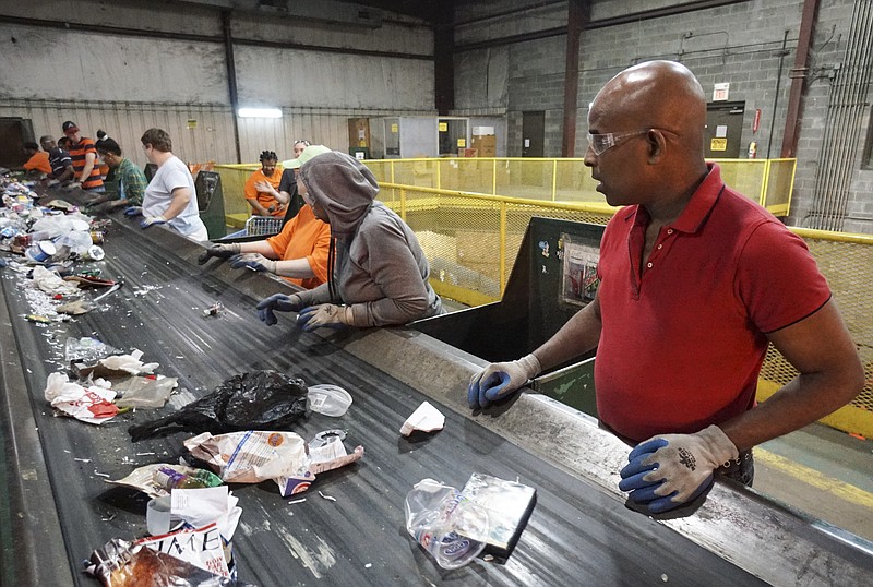 Staff Photo by Dan Henry / The Chattanooga Times Free Press- 7/6/16. Bart, right, and other individuals with intellectual and or developmental disabilities sort items to be recycled at the Orange Grove Material Recovery Facility on Wednesday, June 6, 2016. Orange Grove officials are looking for new employment opportunities for their workers due to a federal mandate requiring greater community engagement in the places where people with intellectual or developmental disabilities can work. The Times Free Press has agreed to identify the individuals served by Orange Grove by only their first names.