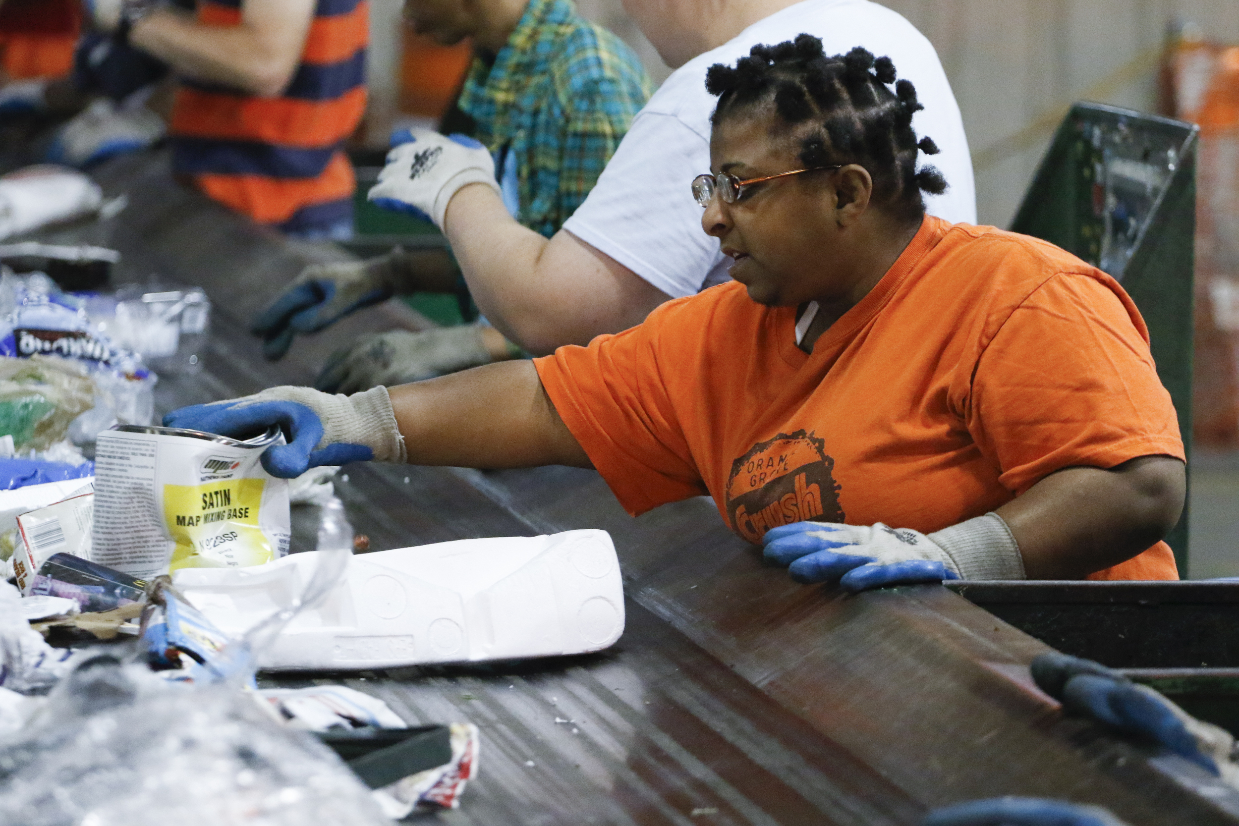 Staff Photo by Dan Henry / The Chattanooga Times Free Press- 7/6/16. Jess, 25, works to sort items to be recycled at the Orange Grove Material Recovery Facility on Wednesday, June 6, 2016.