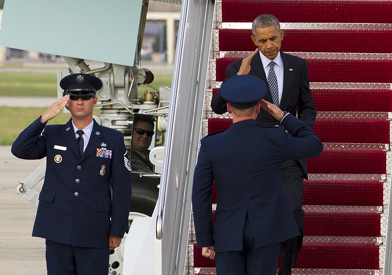 
              President Barack Obama salutes as he walks down the stairs from Air Force One on Tuesday, July 5, 2016, upon his arrival at Andrews Air Force Base, Md. Obama is returning from Charlotte, N.C., after a campaign rally with Democratic presidential candidate Hillary Clinton. ( AP Photo/Jose Luis Magana)
            