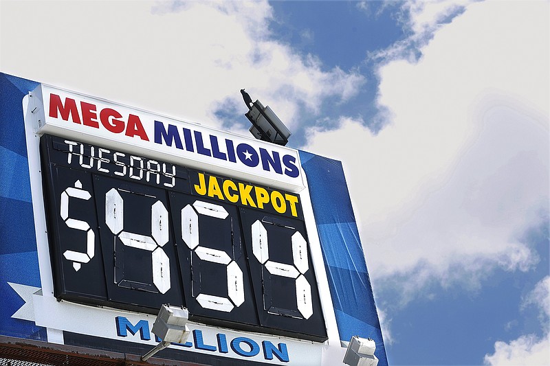 
              An electronic billboard displays the current Mega Millions jackpot, Tuesday, July 5, 2016, in Springfield, Ill. With slightly better odds than Powerball, it's rare that nearly four months passes without someone winning a Mega Millions jackpot, which has grown from $15 million prize to $454 million since the last winning drawing in March. (AP Photo/Seth Perlman)
            