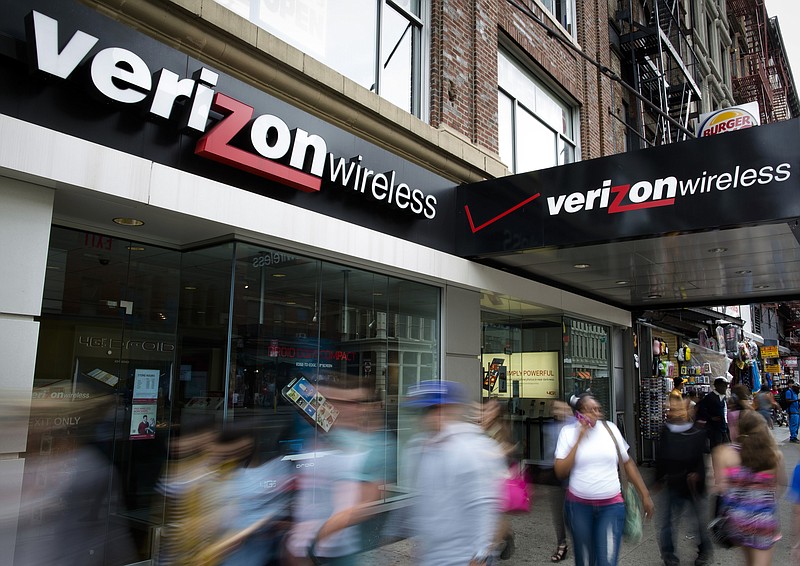 In this June 6, 2013, file photo, pedestrians pass a Verizon Wireless store on Canal Street in New York. Verizon announced Wednesday, July 6, 2016, that the company is hiking prices on its cellphone plans, though the new rates come with changes that might actually save you money. (AP Photo/John Minchillo, File)