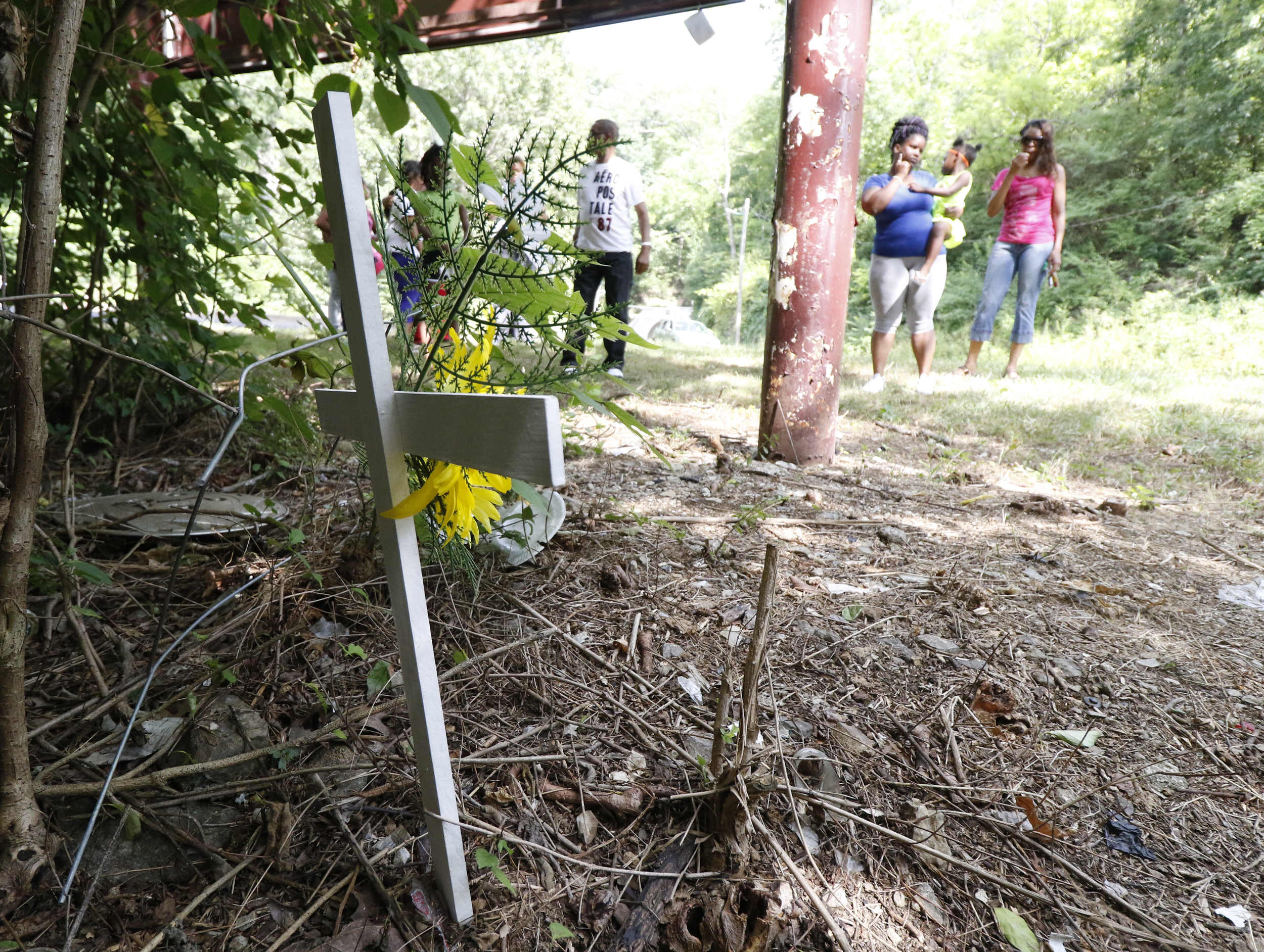 Staff Photo by Dan Henry / The Chattanooga Times Free Press- 7/7/16. Family members gather at the scene of the accident to mourn the loss of Justin LaVon Trimble who lost control of his motorcycle upon exiting the Wilcox Tunnel a month ago.