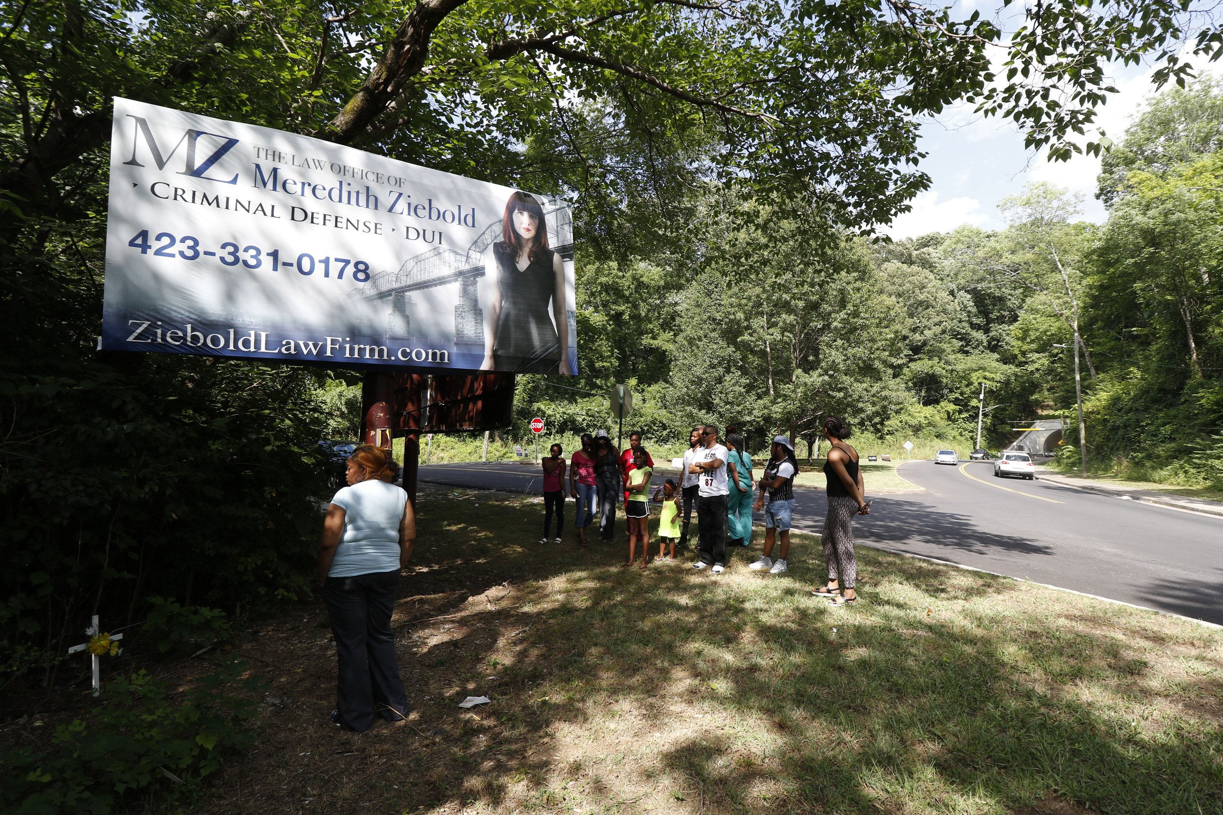 Staff Photo by Dan Henry / The Chattanooga Times Free Press- 7/7/16. Family members gather at the scene of the accident to mourn the loss of Justin LaVon Trimble who lost control of his motorcycle upon exiting the Wilcox Tunnel a month ago.