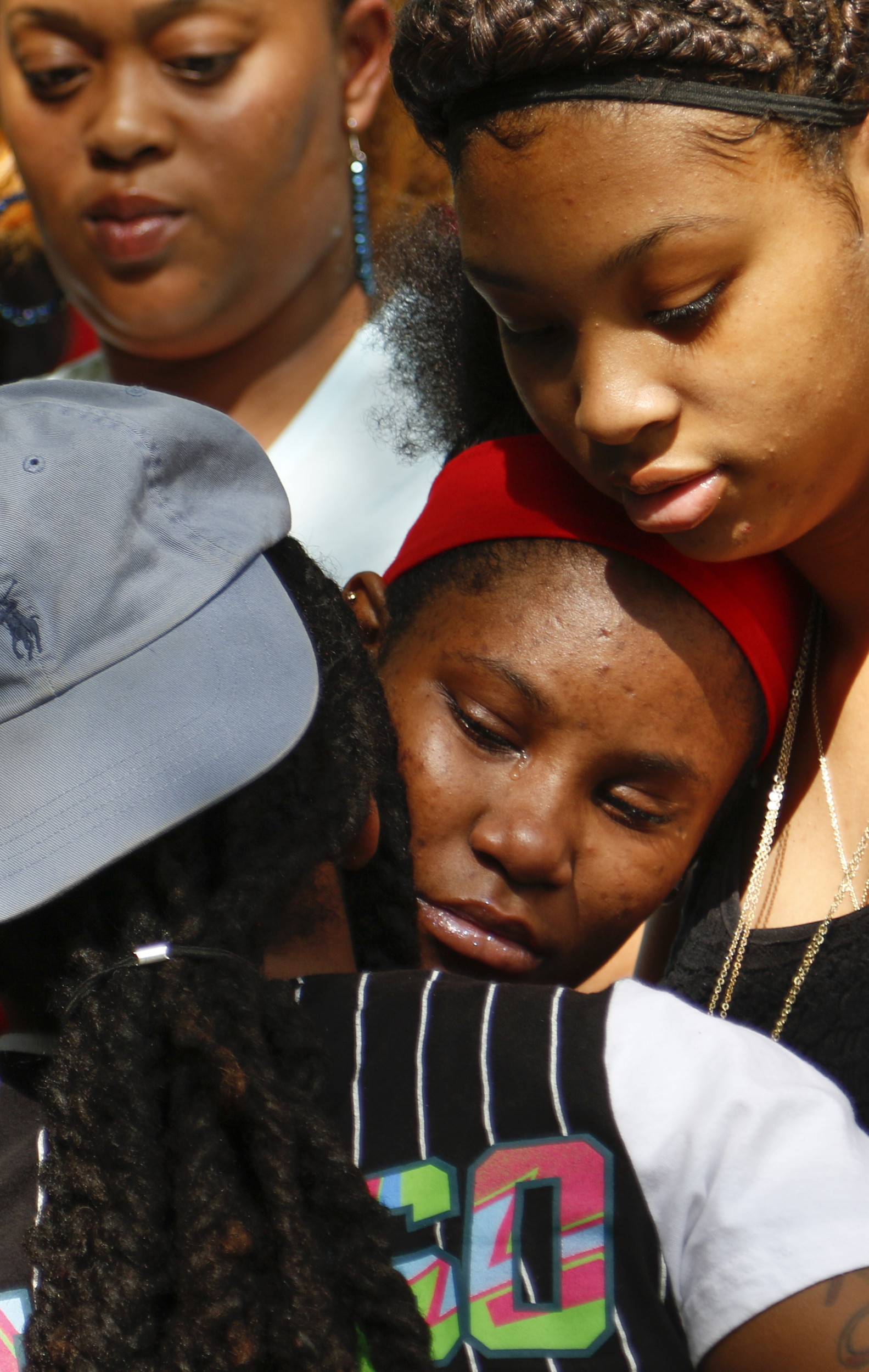Staff Photo by Dan Henry / The Chattanooga Times Free Press- 7/7/16. Deja Trimble, 16, center, is consoled by family members as she mourns the loss of her father, Justin LaVon Trimble, who lost control of his motorcycle and fatally struck a tree upon exiting the Wilcox Tunnel a month ago.