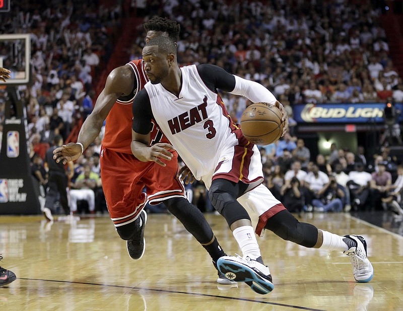 
              FILE - In this April 7, 2016, file photo, Miami Heat guard Dwyane Wade (3) drives around Chicago Bulls guard Jimmy Butler during an NBA basketball game in Miami. A person with knowledge of the situation tells The Associated Press that Wade has decided to leave the Heat and sign with the Bulls. Wade made the decision Wednesday night, July 6, according to the person who spoke on condition of anonymity because nothing can be finalized before Thursday. (AP Photo/Alan Diaz, File)
            