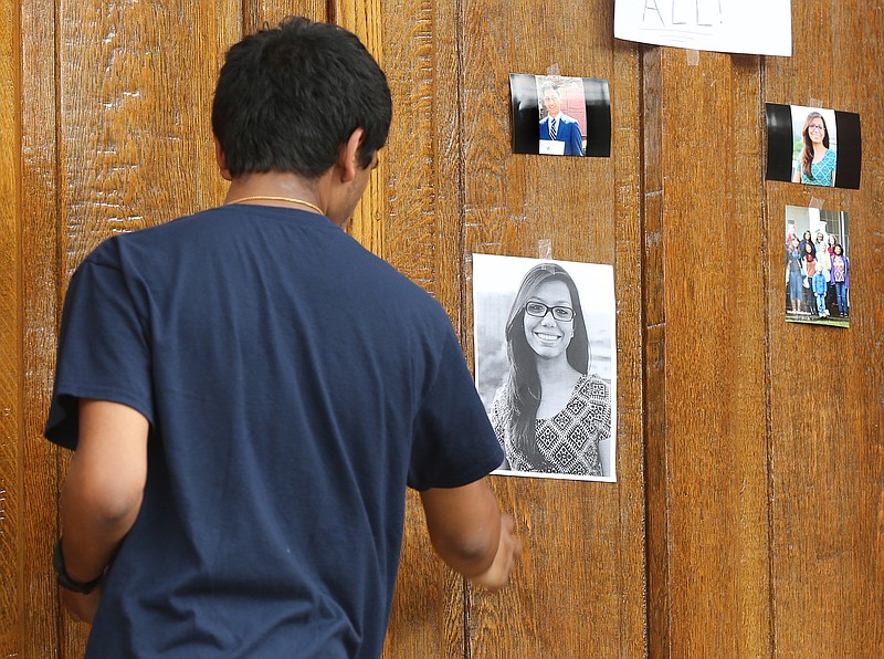 Shankar Taramangalam looks over photographs at a shrine for two fellow Emory University students killed in a Bangladesh militant attack, Abinta Kabir and Faraaz Hossain, at Seney Hall at the Oxford College campus where they attended in Oxford, Georgia, Sunday, July 3, 2016. Kabir and Hossain were among the 20 hostages slain in a brutal attack in an upscale restaurant in Bangladesh's capital.