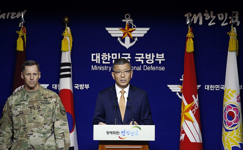 
              South Korean Defense Ministry's Deputy Minister for Policy Yoo Jeh-seung, center, speaks to the media about deploying the Terminal High-Altitude Area Defense, or THAAD as Lt. Gen. Thomas Vandal, the commander of U.S. Forces Korea's Eighth Army, left, listens during a media briefing at the Defense Ministry in Seoul, South Korea, Friday, July 8, 2016. (AP Photo/Lee Jin-man)
            