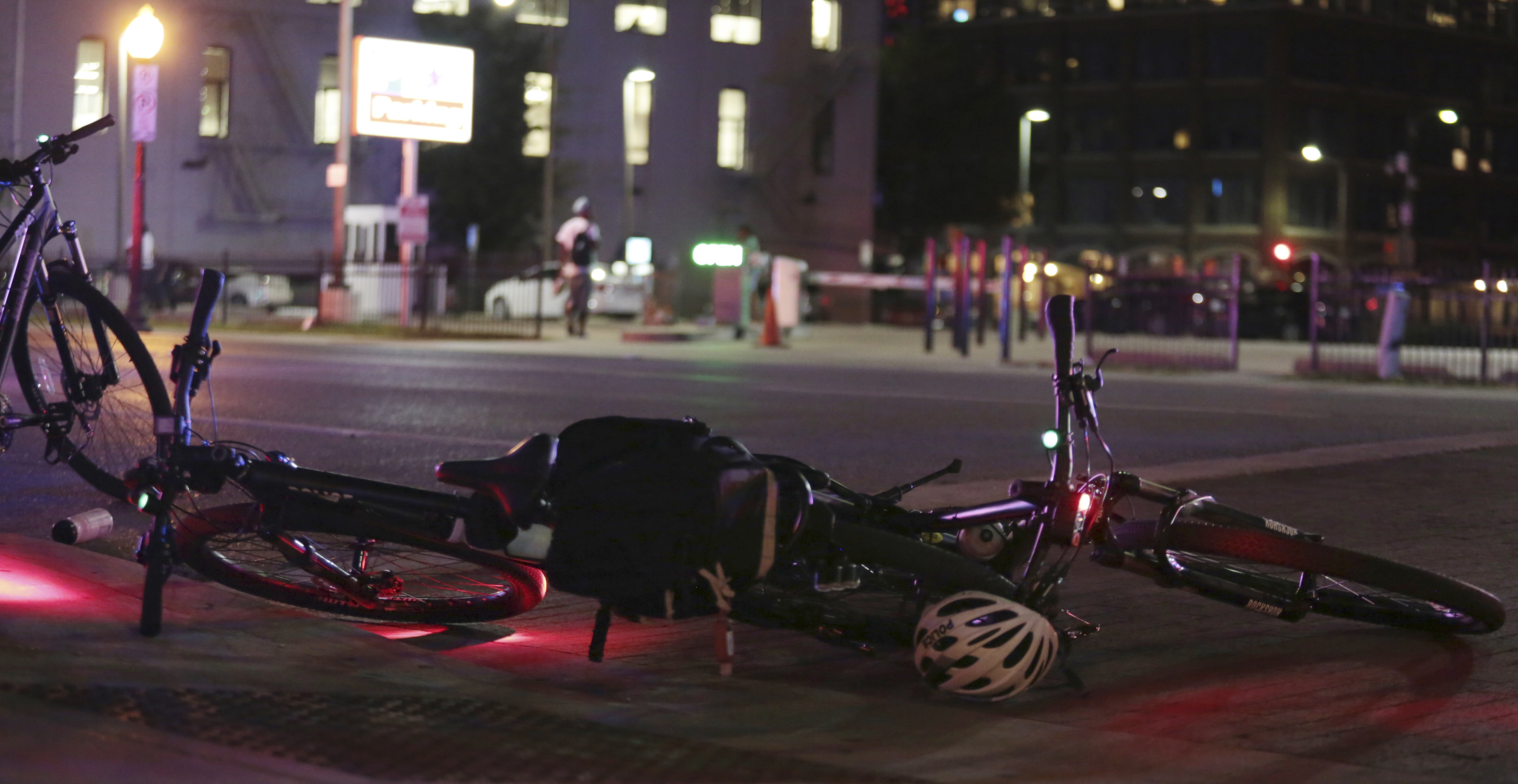 Bicycles used by Dallas police lie on the street Thursday, July 7, 2016, in Dallas. Snipers opened fire on police officers during protests over recent fatal shootings by police in Louisiana and Minnesota; several officers were killed, Dallas police said. (Maria R. Olivas/The Dallas Morning News via AP)
