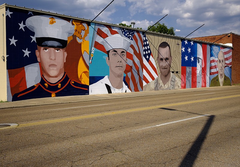 A mural for five fallen servicemen killed in attacks on July 16, 2015 is on a building on McCallie Avenue.