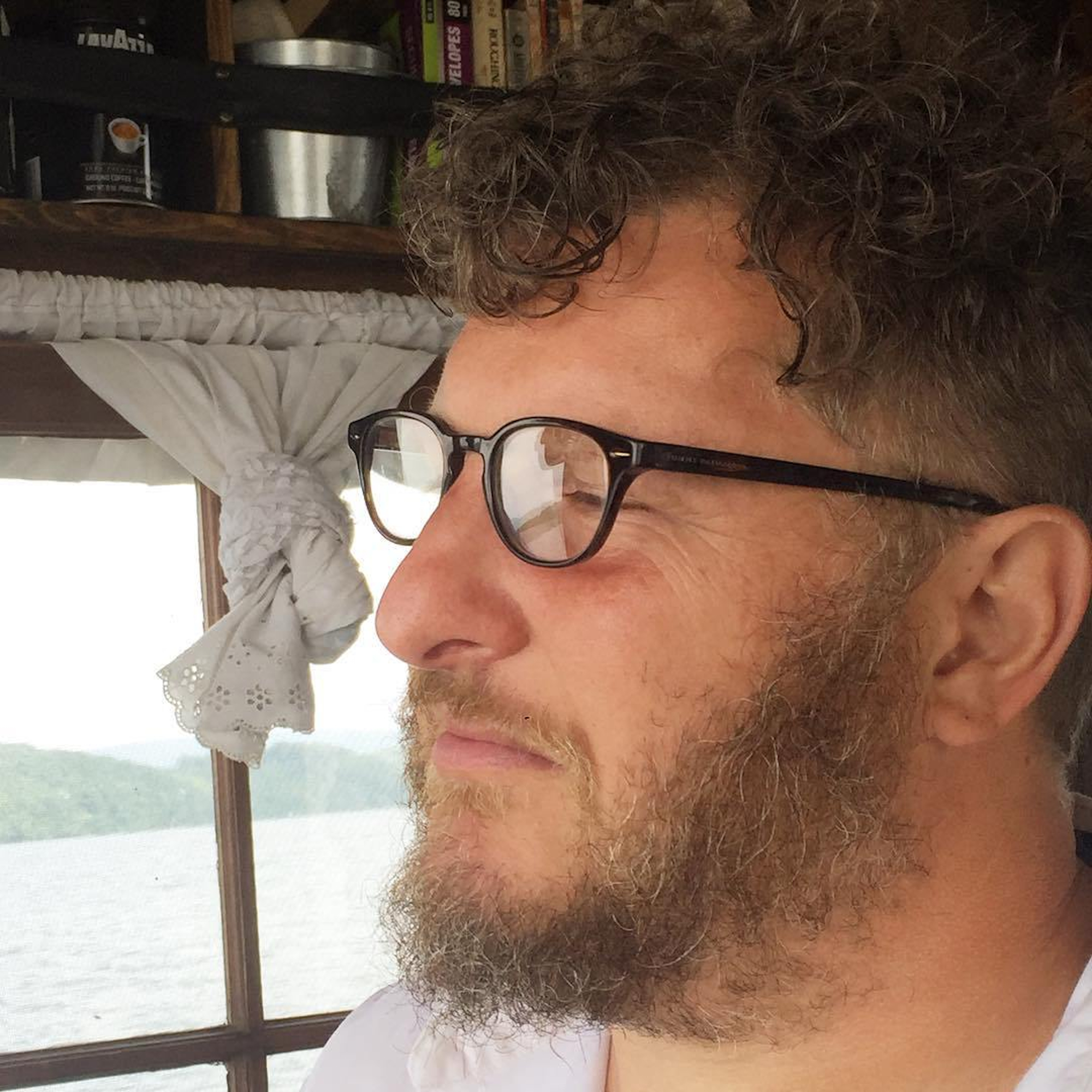 Wes Modes pilots a Shantyboat Dotty boat down the Tennessee River.