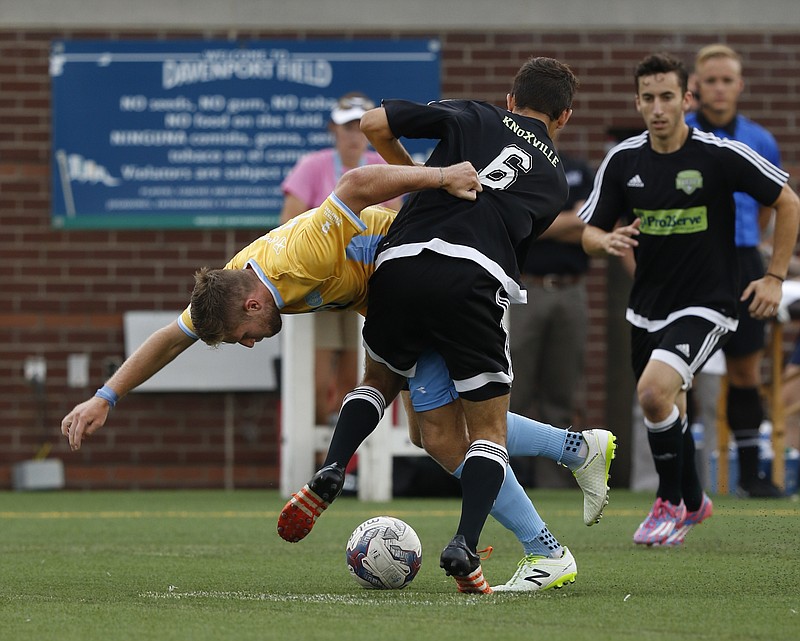 Staff Photo by Dan Henry / The Chattanooga Times Free Press- 7/8/16. Chattanooga Football Club's Luke Winter (17) and Knoxville's Ethan Snow (6) battle for possession of the ball during the first half of play at Finley Stadium on Friday, July 8, 2016. 