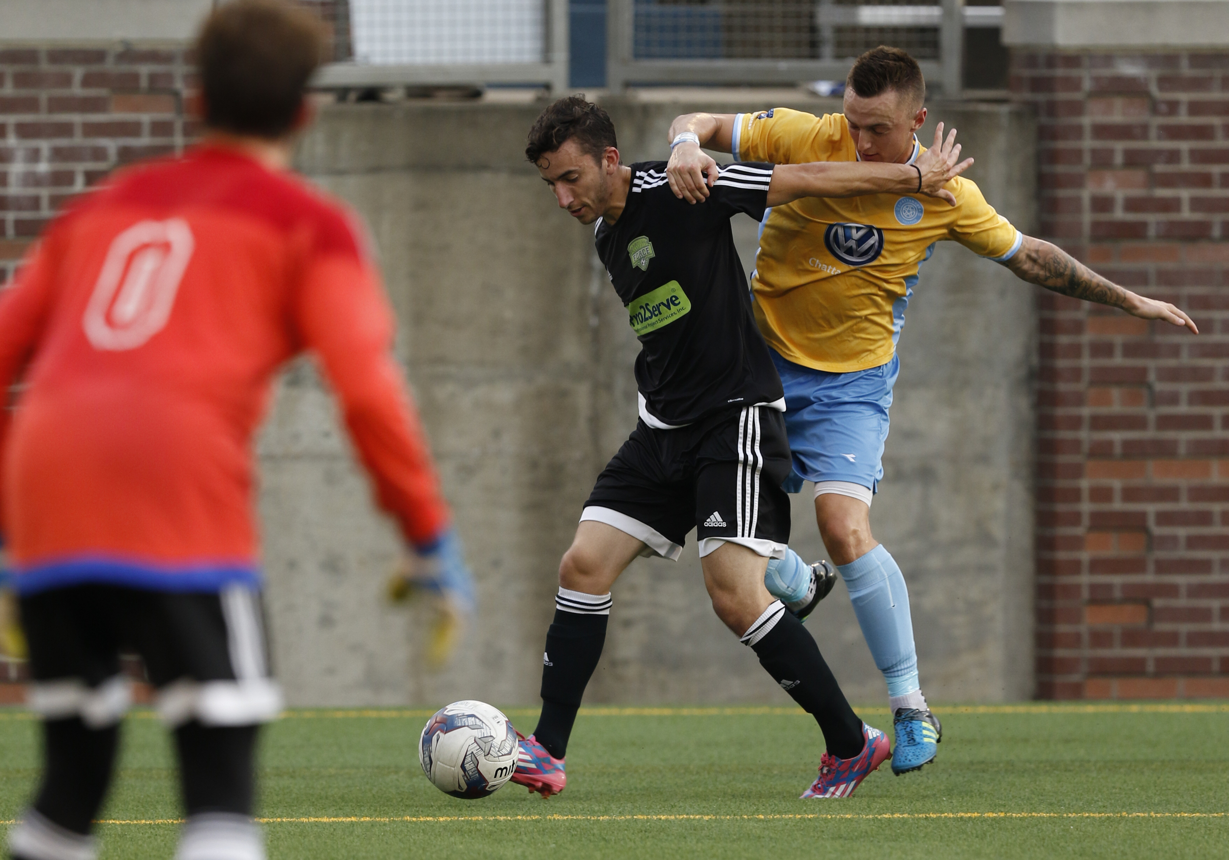 Staff Photo by Dan Henry / The Chattanooga Times Free Press- 7/8/16. Chattanooga Football Club's Jon Finlay (12) and Knoxville's Gustavo Rivera (15) battle for possession of the ball during the first half of play at Finley Stadium on Friday, July 8, 2016.