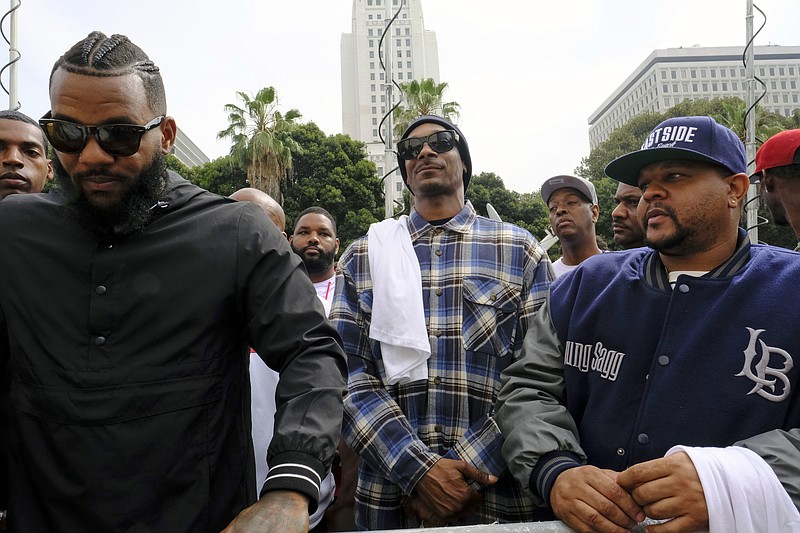 
              Rappers The Game, left, and Snoop Dogg, center, appear at a peaceful unification march outside of the graduation ceremony for the latest class of Los Angeles Police recruits in Los Angeles, Friday, July 8, 2016. Snoop shook hands with police officials and told reporters he hoped his presence would help reintroduce the black community to the Police Department and open a dialogue. The gathering comes a day after the shooting deaths of multiple police officers in Dallas on Thursday night.  (AP Photo/Richard Vogel)
            