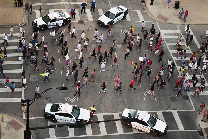 
              Protesters march during a Black Live Matter rally in downtown Dallas on Thursday, July 7, 2016. Multiple media outlets report that shots were fired later Thursday during the protest over two recent fatal police shootings of black men. (Smiley N. Pool/The Dallas Morning News via AP)
            