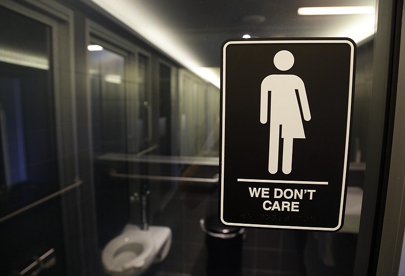 
              In this Thursday, May 12, 2016 file photo, signage is seen outside a restroom at 21c Museum Hotel in Durham, N.C. Ten states sued the federal government Friday, July 8, 2016 over rules requiring public schools to allow transgender students to use restrooms conforming to their gender identity, joining a dozen other states in the latest fight over LGBT rights. (AP Photo/Gerry Broome, File)
            
