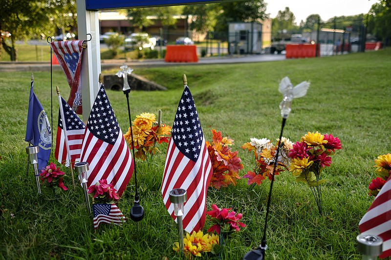 Flags and flowers are posted outside the Naval Operational Support Center and Marine Corps Reserve Center last month in Chattanooga. The center was one of two military facilities attacked by a gunman on July 16, 2015.