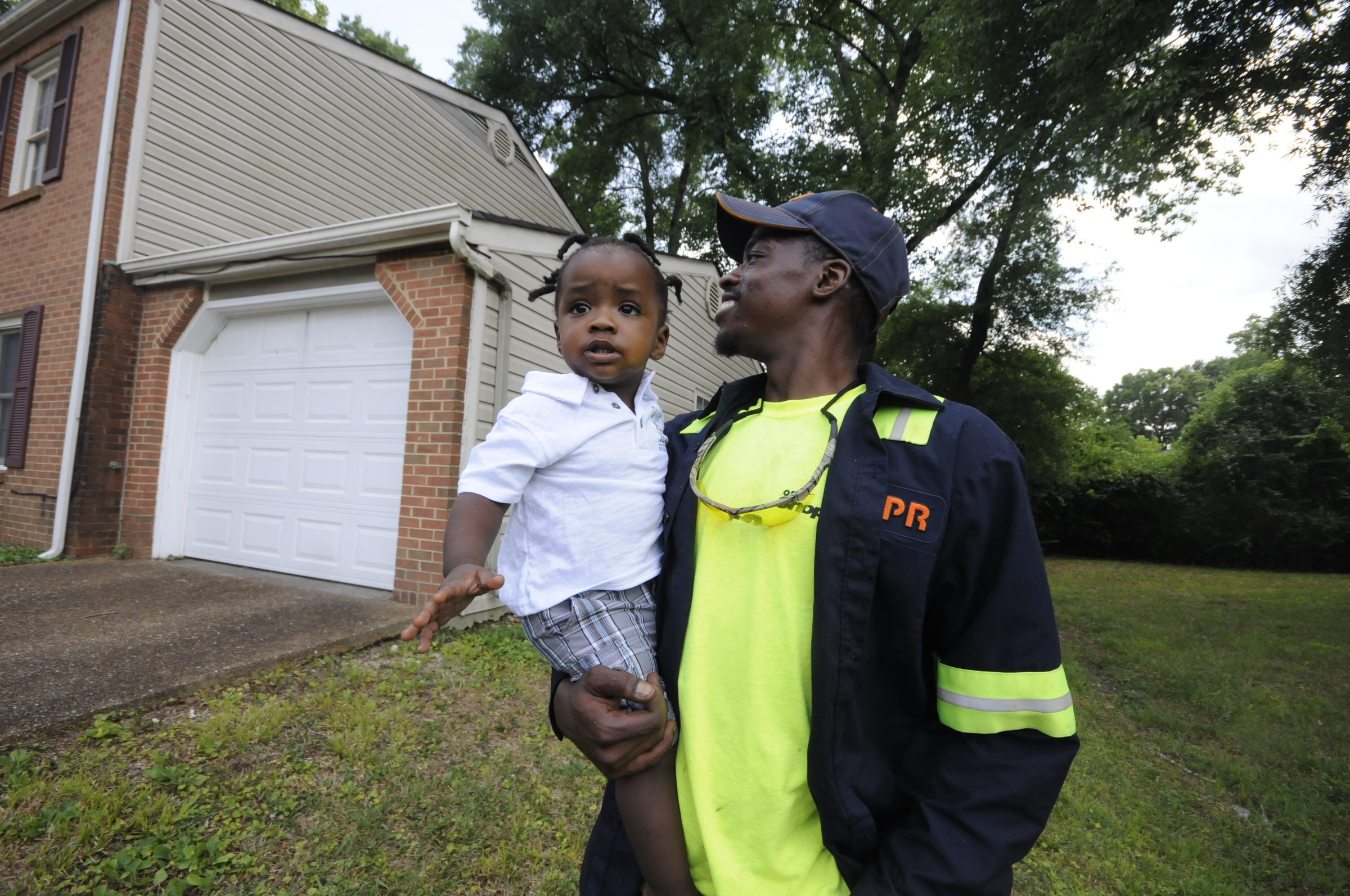 Upon arriving to his East Ridge residence, Jimmie Lebron Williams greets his son, Kaptain Levi Williams, 1, right after work last week.