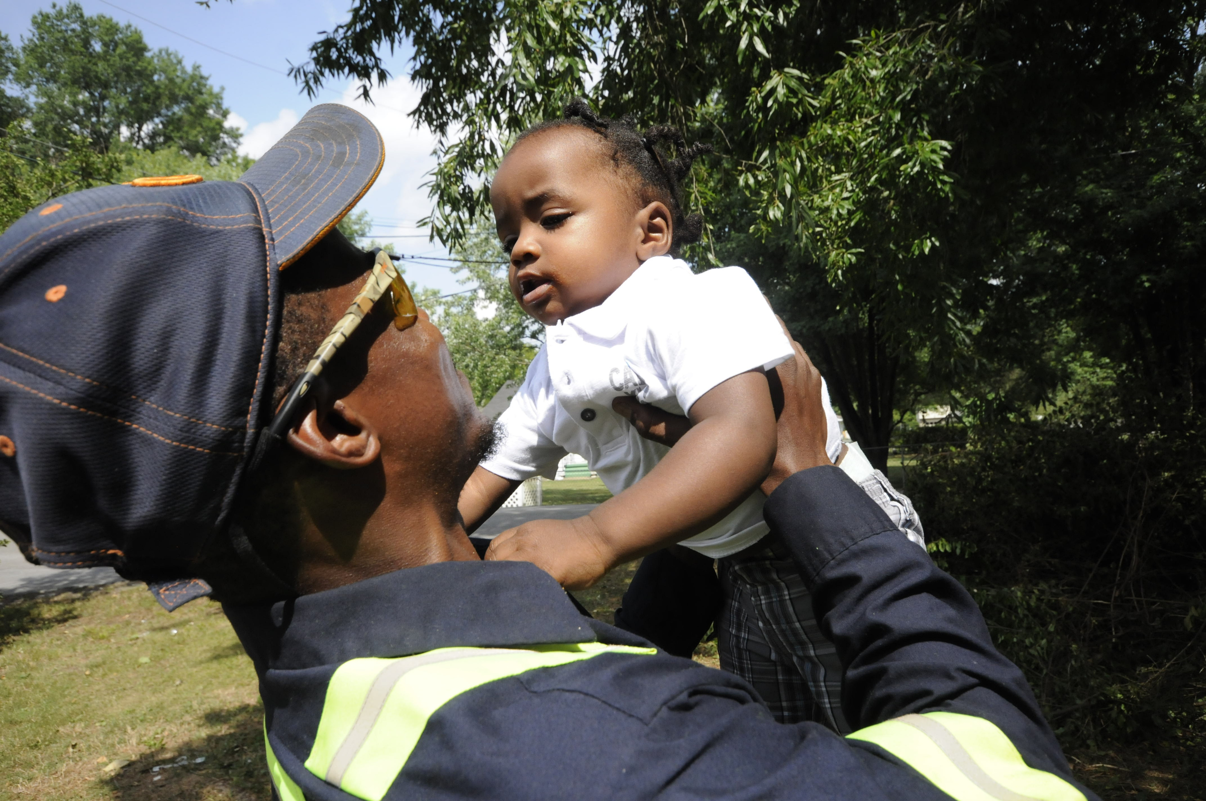 Upon arriving to his East Ridge residence, Jimmie Lebron Williams greets his son, Kaptain Levi Williams, 1, right after work last week.