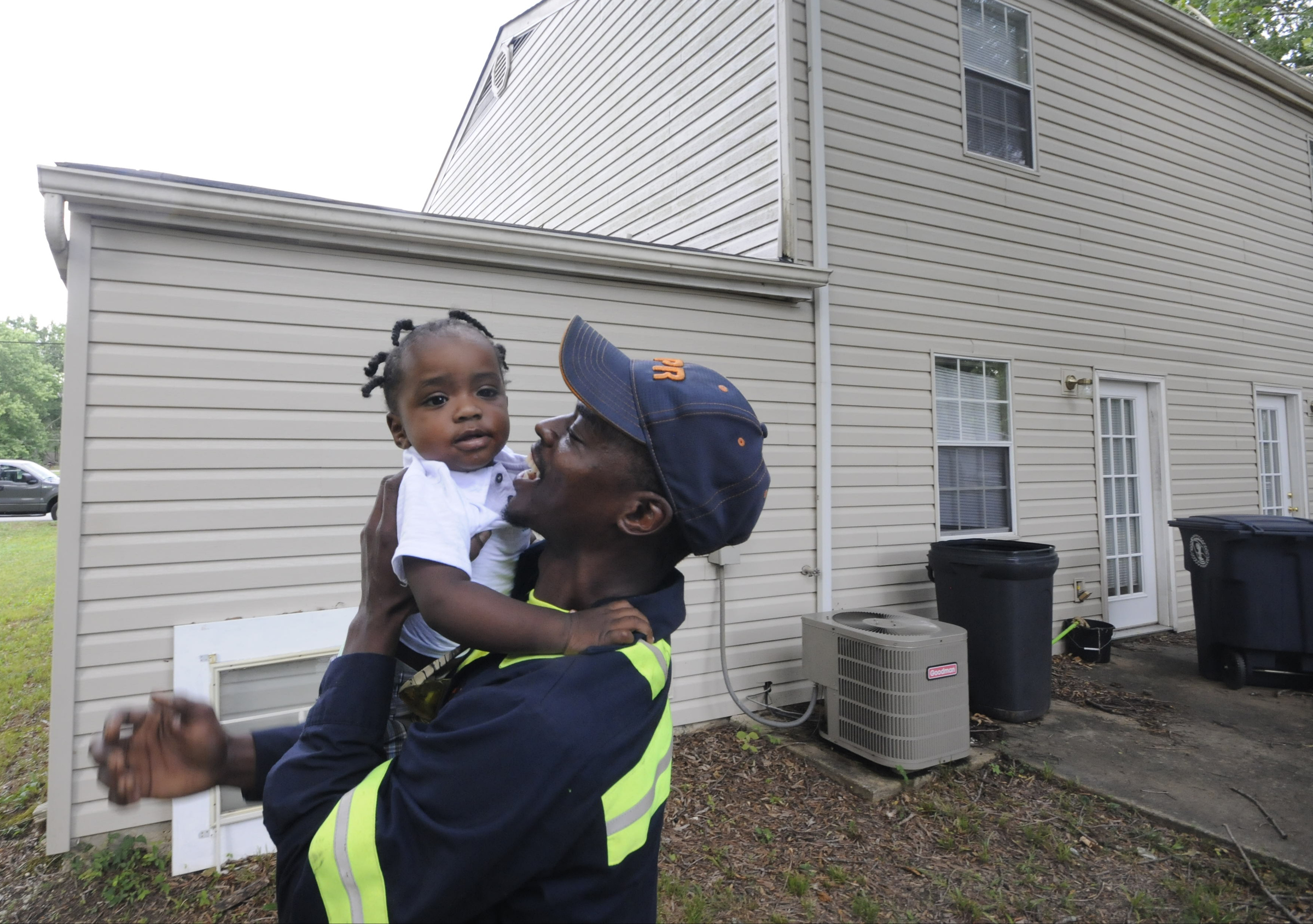 Upon arriving to his East Ridge residence, Jimmie Lebron Williams greets his son, Kaptain Levi Williams, 1, right after work last week.