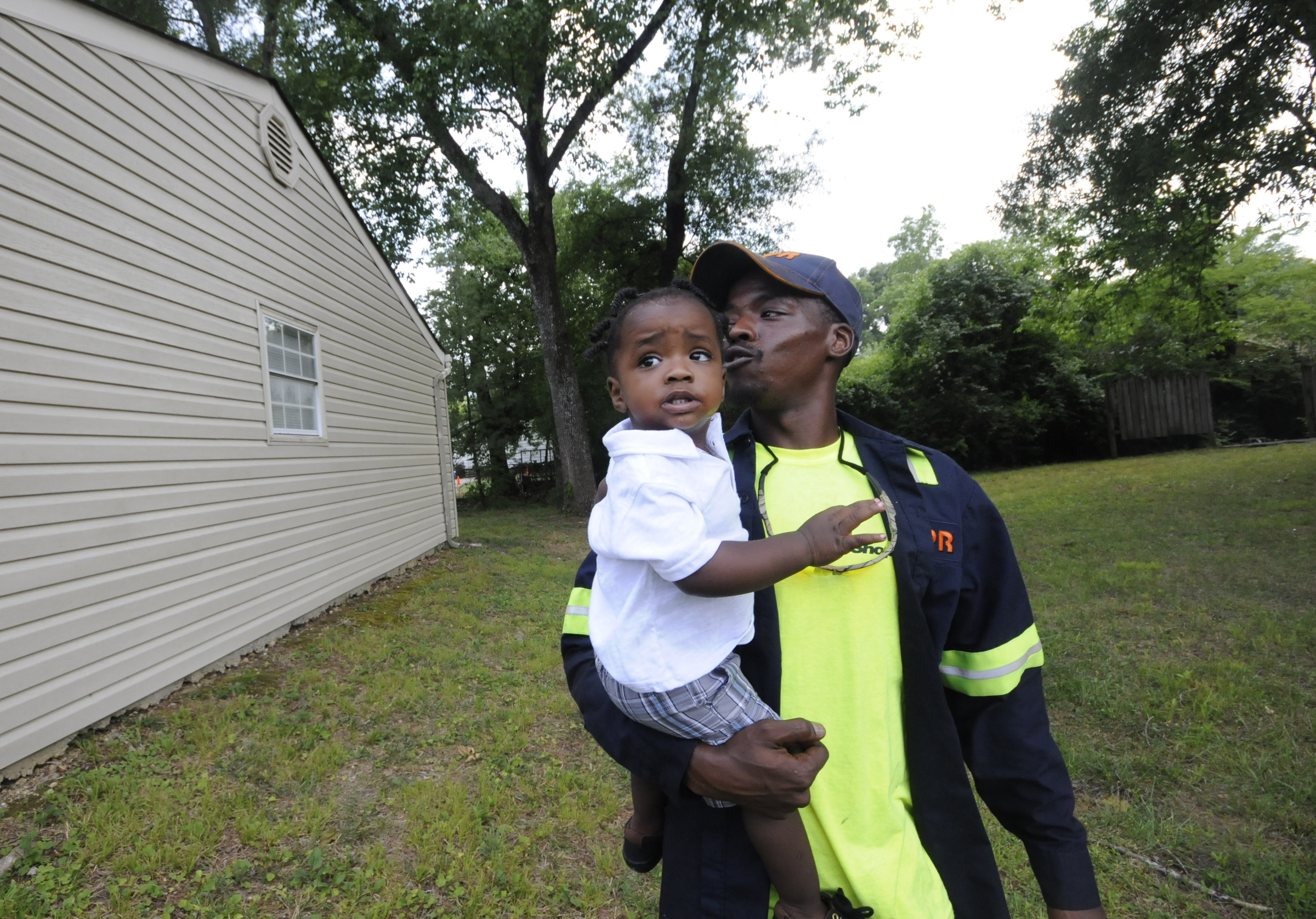 Upon arriving to his East Ridge residence, Jimmie Lebron Williams greets his son, Kaptain Levi Williams, 1, right after work last week.