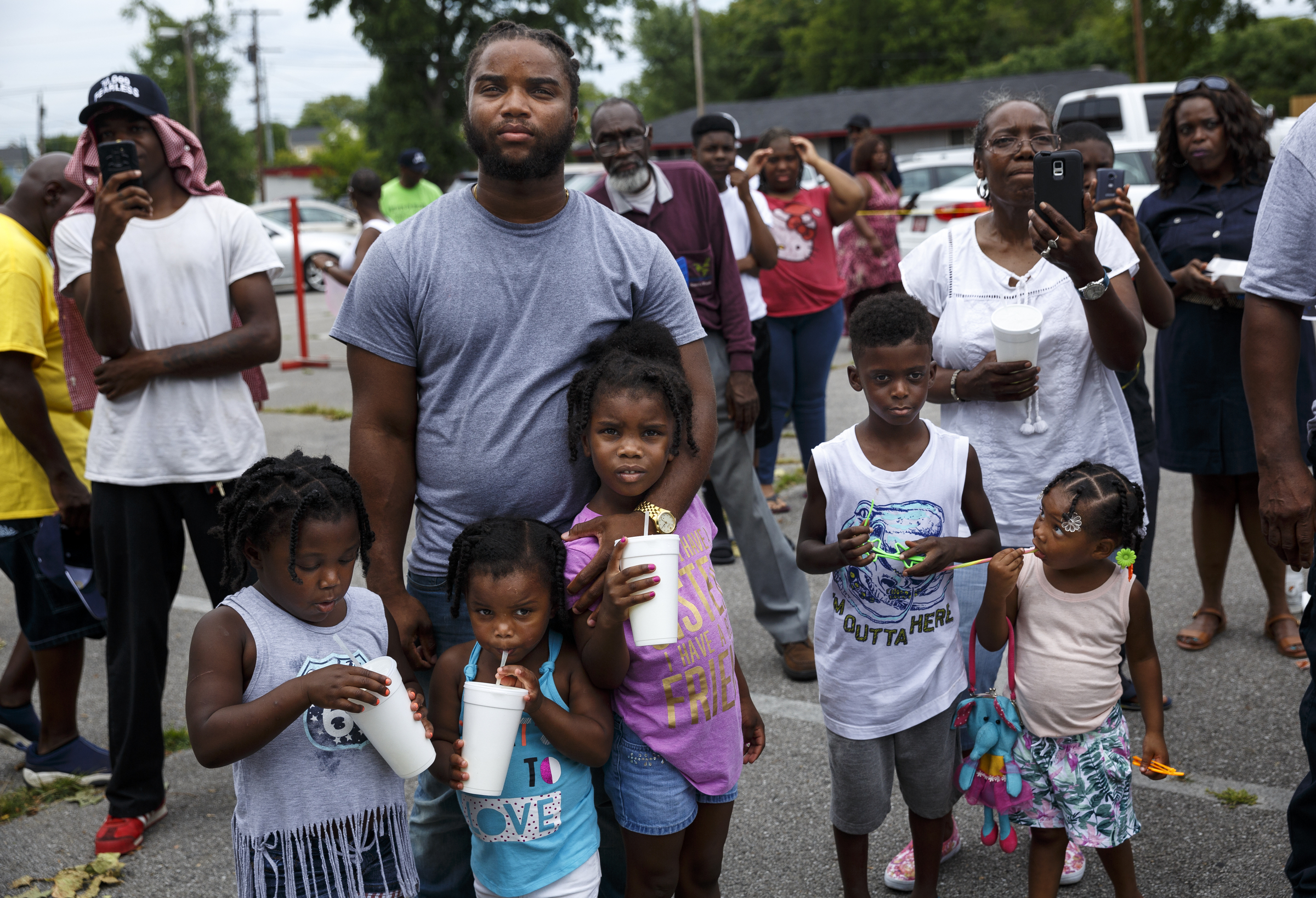 People watch rapper Tru Saint perform at a block party and fundraiser at Westside Baptist Church held to raise money for community projects to make Alton Park a better place to live on Saturday, July 9, 2016, in Chattanooga, Tenn. The fundraiser, organized by Westside Baptist Church and the Nation of Islam, was held to assist in the establishment of the Community Haven which will include a nutrition and healthy eating program, counseling, and other services.