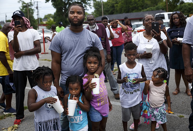 People watch rapper Tru Saint perform at a block party and fundraiser at Westside Baptist Church held to raise money for community projects to make Alton Park a better place to live on Saturday, July 9, 2016, in Chattanooga, Tenn. The fundraiser, organized by Westside Baptist Church and the Nation of Islam, was held to assist in the establishment of the Community Haven which will include a nutrition and healthy eating program, counseling, and other services.