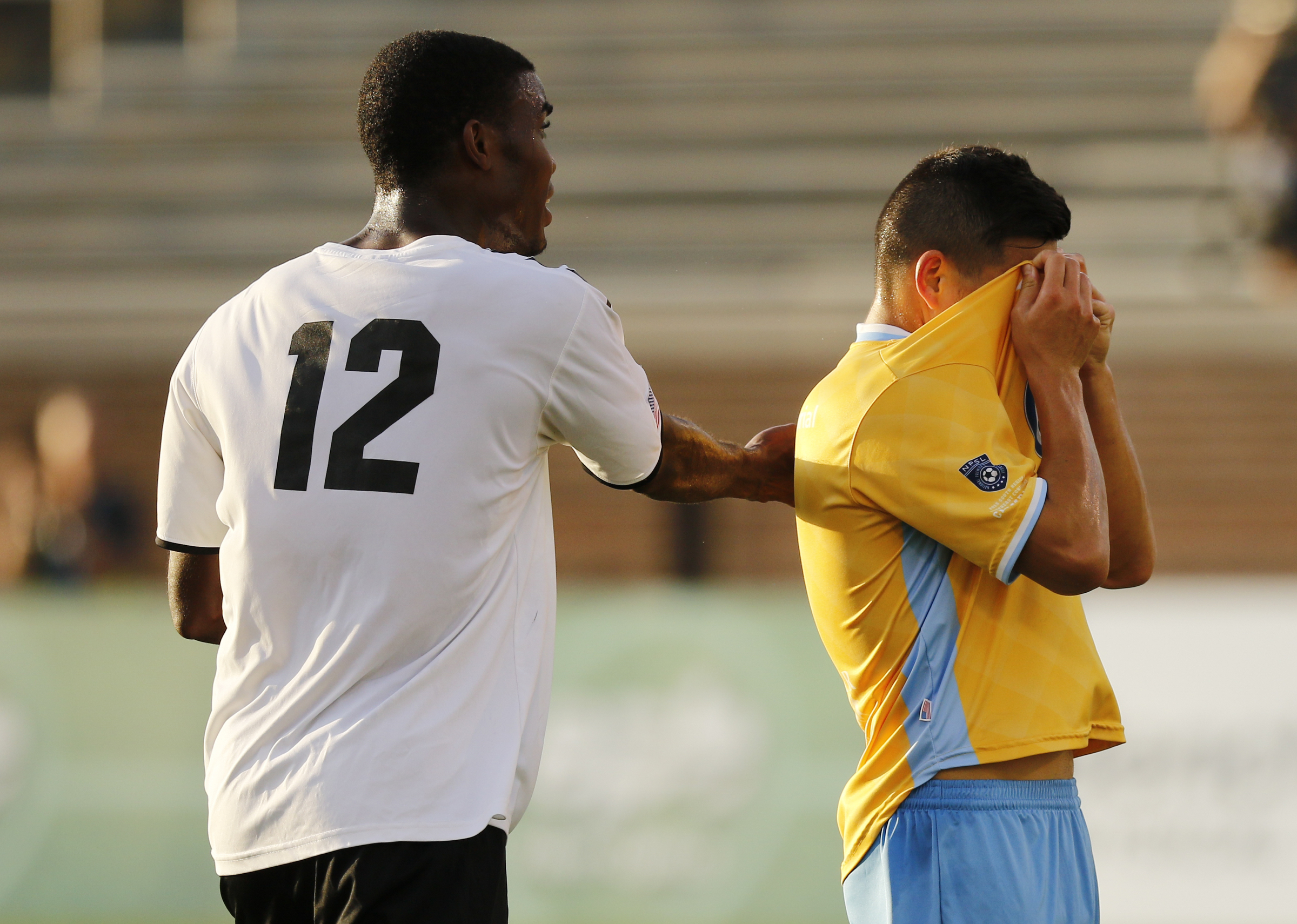 Memphis's Mario Hyman taps CFC's John Carrier on the back after Carrier missed a shot on the goal during Chattanooga FC's playoff match against Memphis City at Finley Stadium on Saturday, July 9, 2016, in Chattanooga, Tenn.