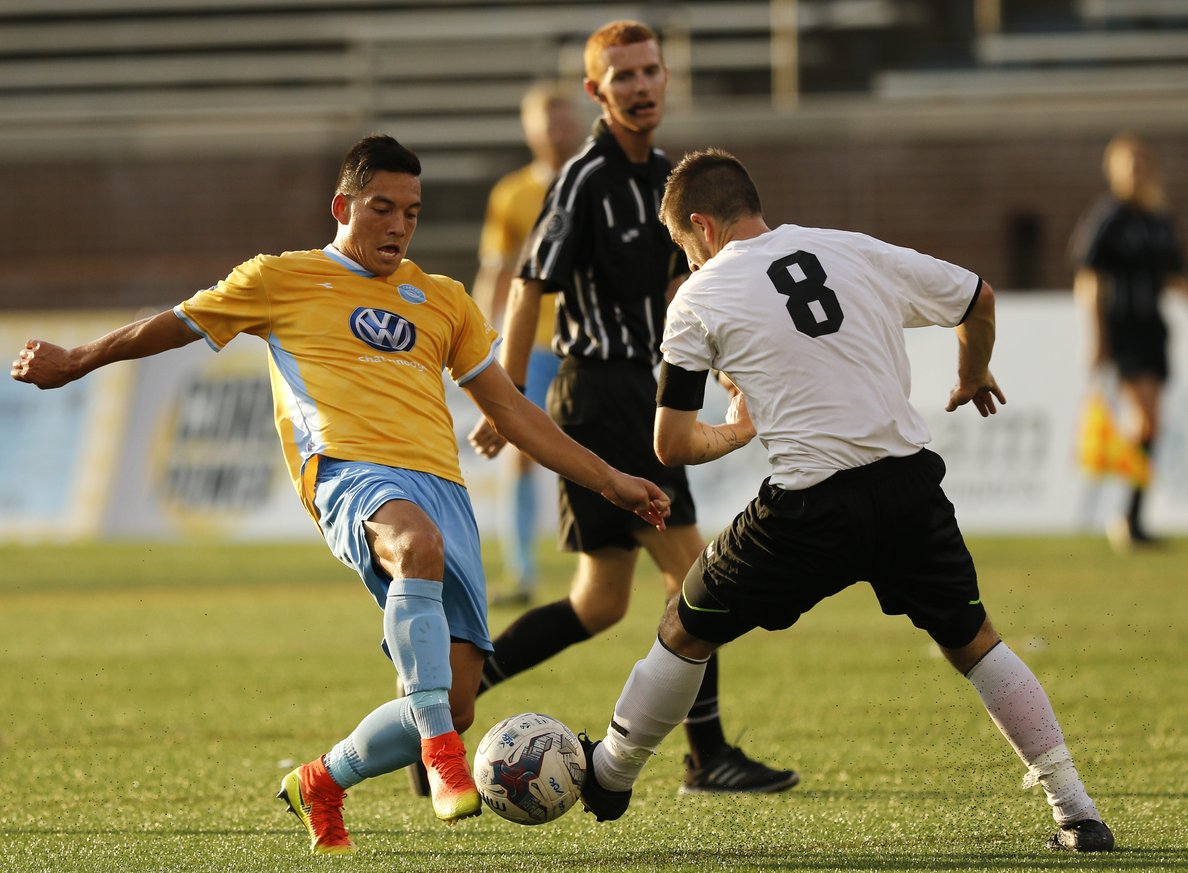 CFC's John Carrier, left, takes a shot into Memphis's Neil Cummings during Chattanooga FC's playoff match against Memphis City at Finley Stadium on Saturday, July 9, 2016, in Chattanooga, Tenn.