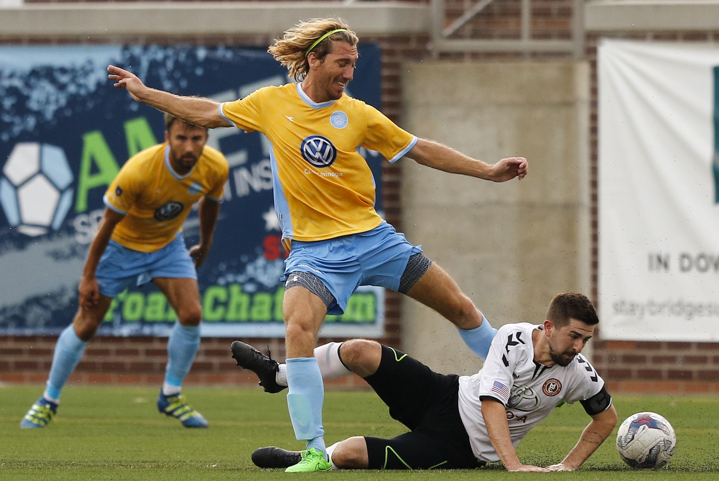CFC's Juan Hernandez Mendizabal gets caught up by Memphis's Neil Cummings as he hits the ground during Chattanooga FC's playoff match against Memphis City at Finley Stadium on Saturday, July 9, 2016, in Chattanooga, Tenn.