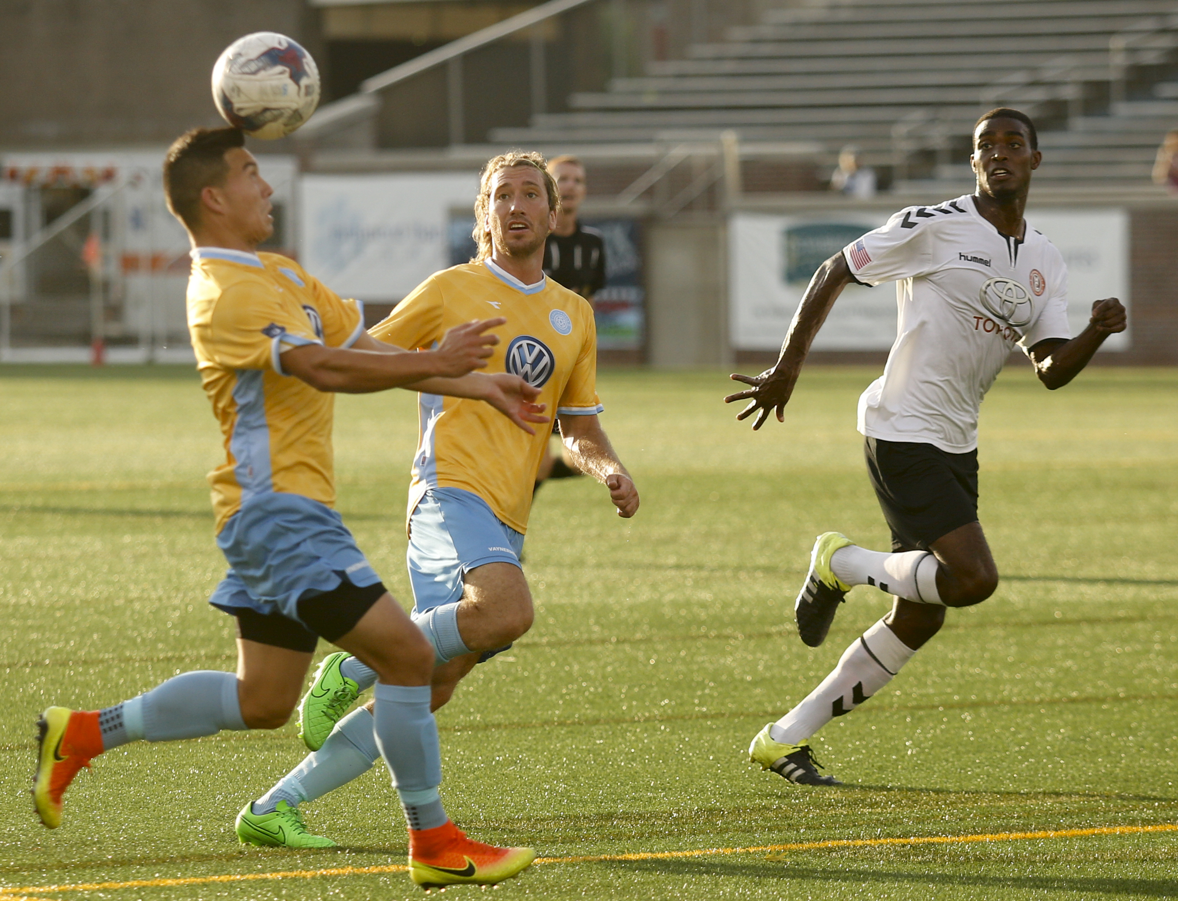 CFC's John Carrier heads the ball to teammate Juan Hernandez Mendizabal as Memphis's Mario Hyman runs ahead during Chattanooga FC's playoff match against Memphis City at Finley Stadium on Saturday, July 9, 2016, in Chattanooga, Tenn.
