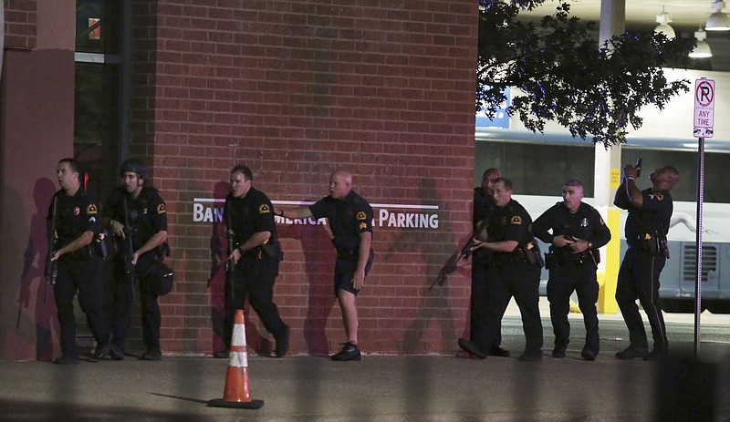 
              Dallas police respond after shots were fired  during a protest over recent fatal shootings by police in Louisiana and Minnesota, Thursday, July 7, 2016, in Dallas. Snipers opened fire on police officers during protests; several officers were killed, police said. (Maria R. Olivas/The Dallas Morning News via AP)
            