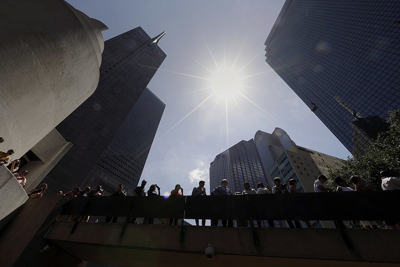 People take part in a prayer vigil at Thanksgiving Square, Friday, July 8, 2016, in Dallas. Five police officers are dead and several injured following a shooting in downtown Dallas Thursday night.