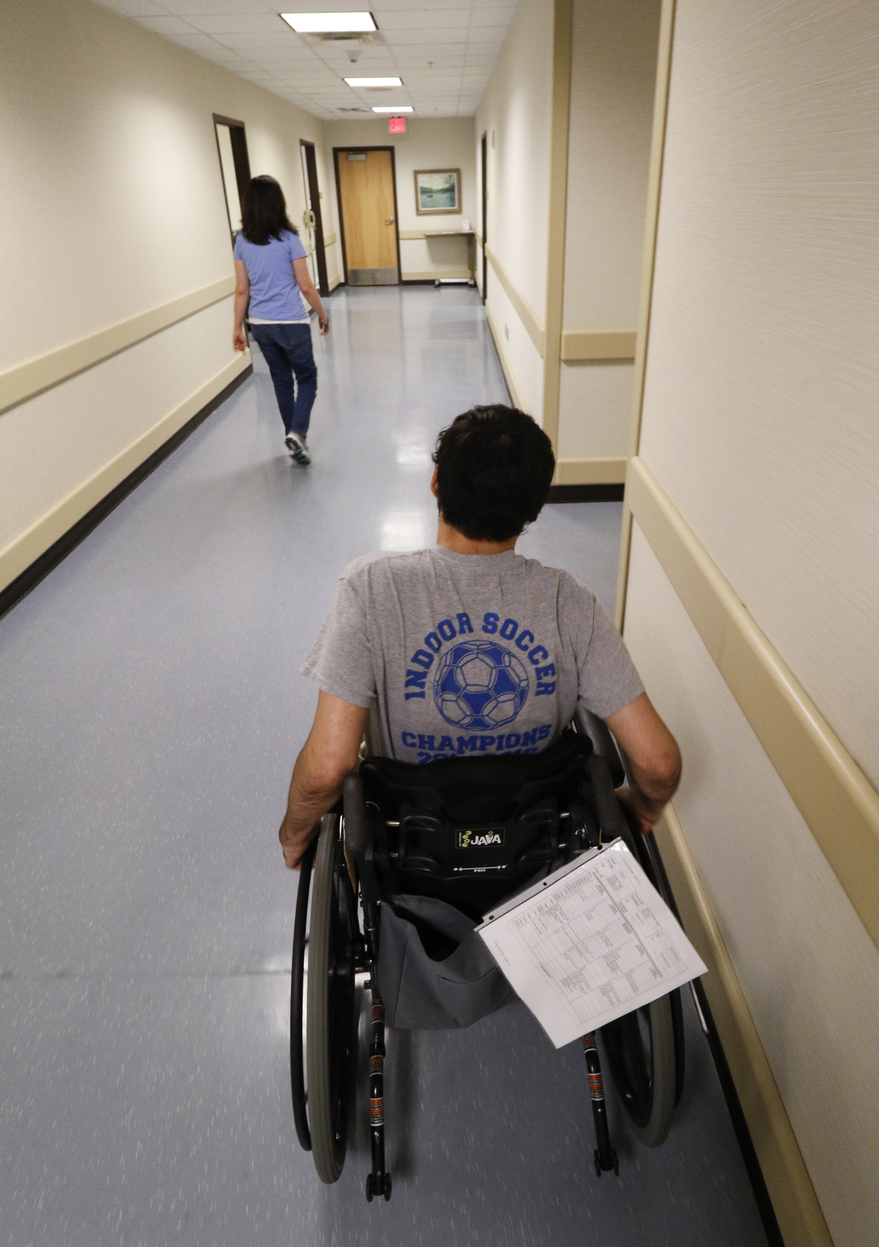 Staff Photo by Dan Henry / The Chattanooga Times Free Press- 6/27/16. Joel Elmore follows Sara Brockman, an occupational therapist at the Shepherd Center, as she works with him at the rehabilitation center in Atlanta, Ga., on Monday, June 27, 2016. Elmore, a 22-year-old, contracted Guillain-Barre Syndrome in his senior year of college and was totally immobilized but is now going through physical rehab at Shepherd.