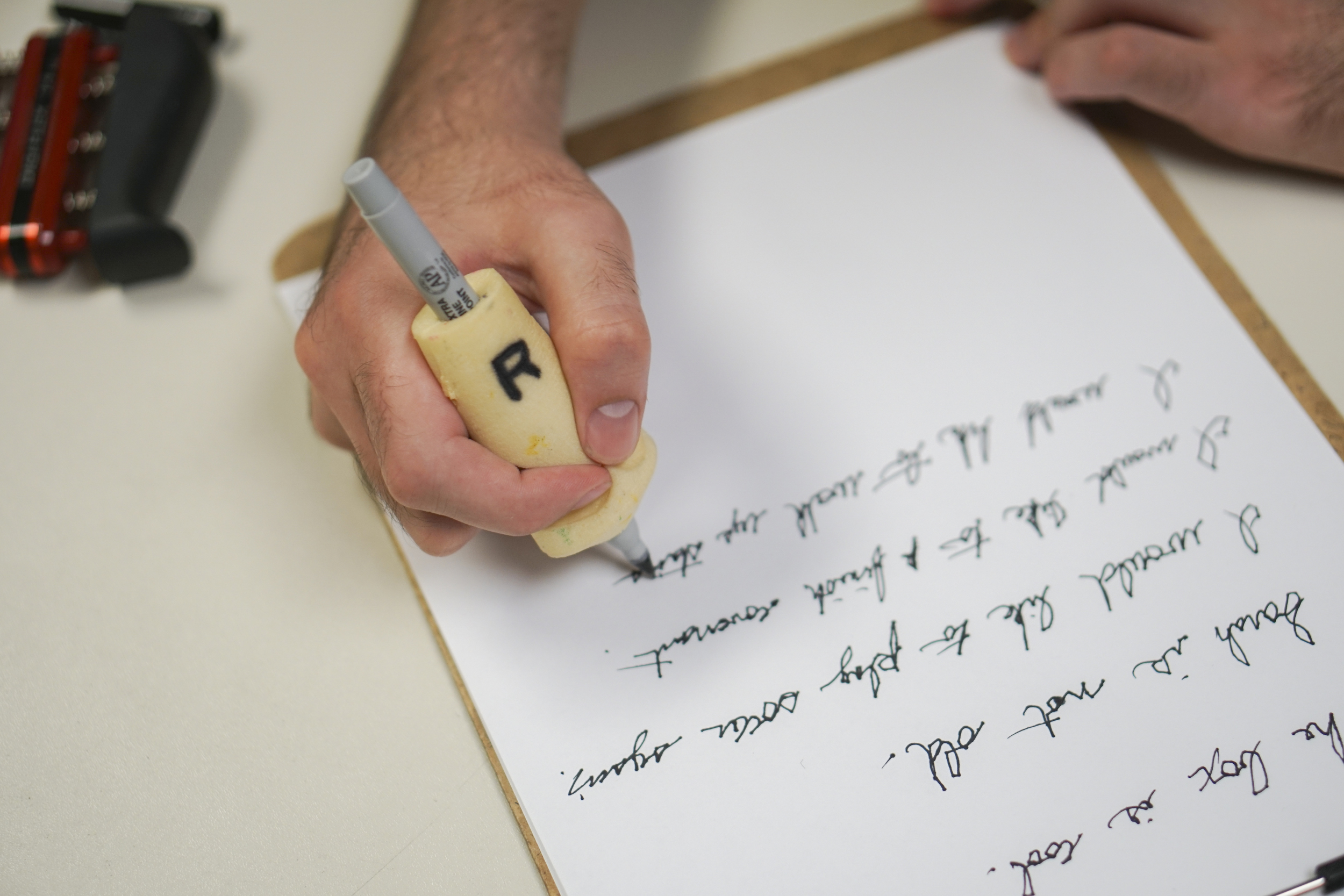 Staff Photo by Dan Henry / The Chattanooga Times Free Press- 6/27/16. Joel Elmore works to regain hand dexterity and writing skills while at the Shepherd Center in Atlanta, Ga., on Monday, June 27, 2016. Elmore, a 22-year-old, contracted Guillain-Barre Syndrome in his senior year of college and was totally immobilized but is now going through physical rehab at Shepherd.