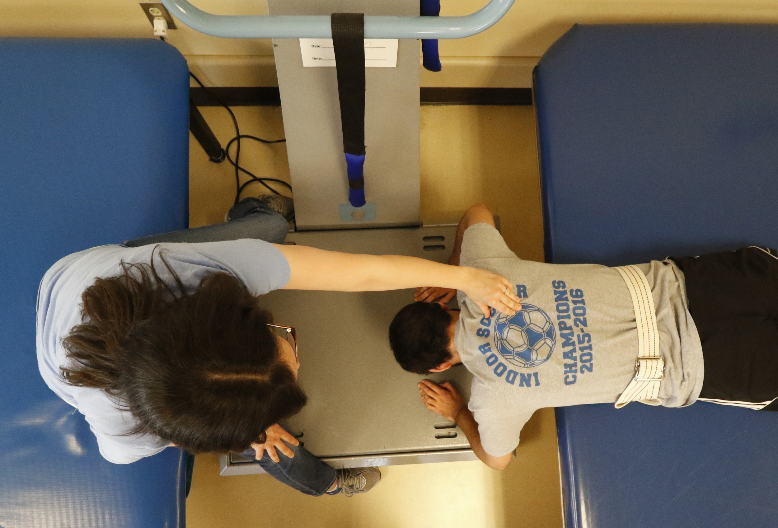 Staff Photo by Dan Henry / The Chattanooga Times Free Press- 6/27/16. Sara Brockman, an occupational therapist at the Shepherd Center, works with Joel Elmore as he performs pushups on a WAVE machine to help him regain core strength and muscle dexterity while at the rehabilitation center in Atlanta, Ga., on Monday, June 27, 2016. Elmore, a 22-year-old, contracted Guillain-Barre Syndrome in his senior year of college and was totally immobilized but is now going through physical rehab at Shepherd.