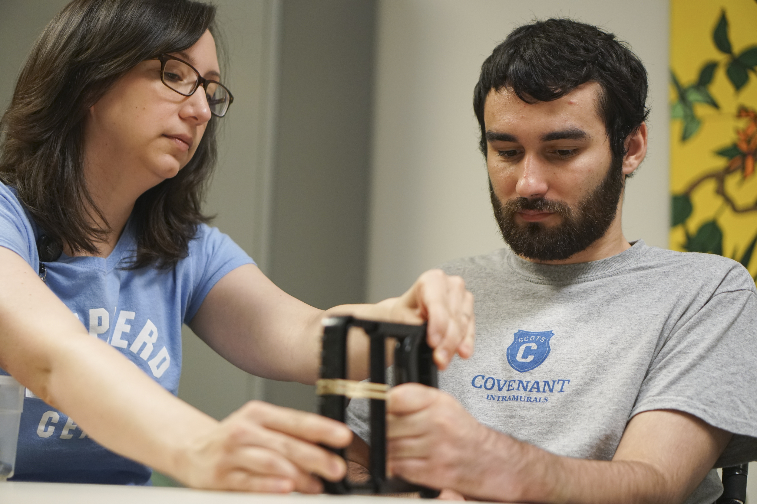 Staff Photo by Dan Henry / The Chattanooga Times Free Press- 6/27/16. Sara Brockman, an occupational therapist at the Shepherd Center, works with Joel Elmore to help him regain hand dexterity while at the rehabilitation center in Atlanta, Ga., on Monday, June 27, 2016. Elmore, a 22-year-old, contracted Guillain-Barre Syndrome in his senior year of college and was totally immobilized but is now going through physical rehab at Shepherd.