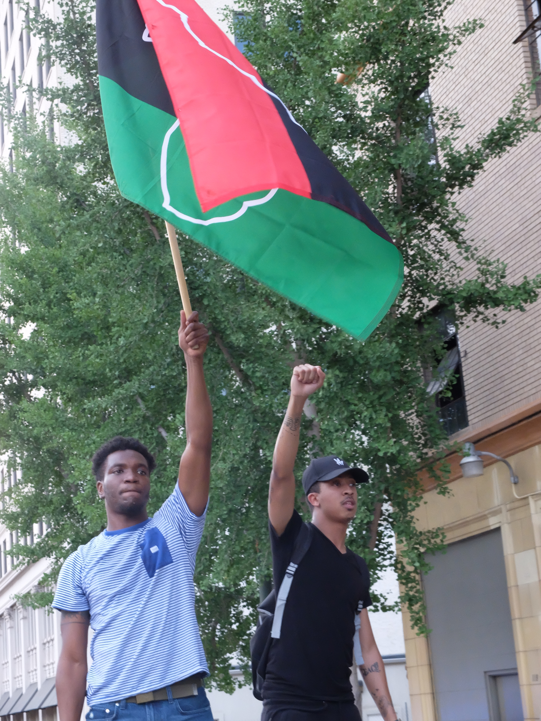 Leonard Jackson III, left, and Jeremy Lawrence ride on the lead car as a march to end violence proceeds on M.L. King Blvd. in downtown Chattanooga late Sunday. The march began and ended at Coolidge Park on the Northshore in downtown Chattanooga. Participants walked for more than two hours beginning at 6 p.m., making the loop across the Tennessee River to downtown and back across ending at 8:25 p.m.