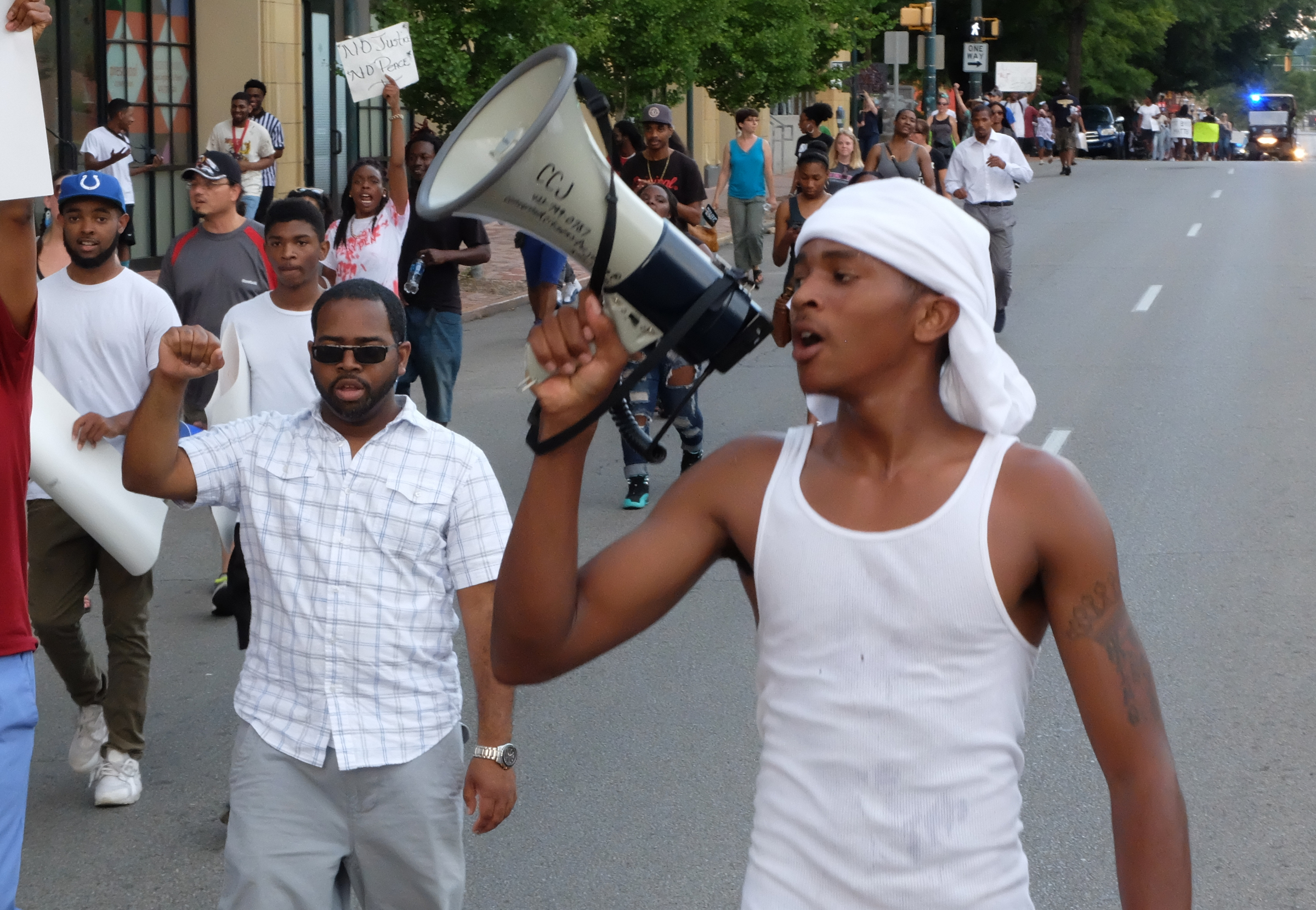 David Mobley calls out to participants in a march to end violence on M.L. King Blvd. late Sunday. The march began and ended at Coolidge Park on the Northshore in downtown Chattanooga. Participants walked for more than two hours beginning at 6 p.m., making the loop across the Tennessee River to downtown and back across ending at 8:25 p.m.