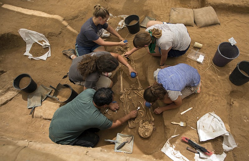 
              This Tuesday, June 28, 2016 photo shows archeologists excavating an ancient Phillstine cemetery near Ashkelon, Israel. The recent archaeological discovery in Israel may help solve a biblical mystery of where the ancient Philistines came from. A team of archaeologists excavating at the site of the biblical city of Ashkelon have announced it found the first Philistine cemetery ever to be discovered. Now the team is performing DNA, radiocarbon and other tests on bone samples found at the cemetery, dating to the 11th to 8th centuries B.C. (AP Photo/Tsafrir Abayov)
            