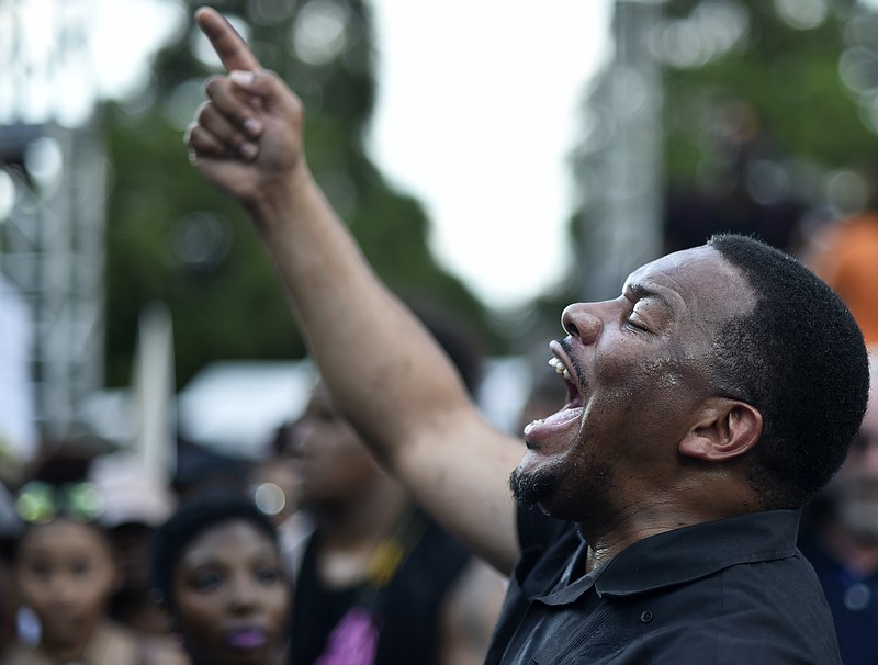Francys Johnson state president of the Georgia NAACP chants in Centennial Olympic Park during a march through downtown Atlanta to protest the shootings of two black men by police officers, Friday, July 8, 2016. 