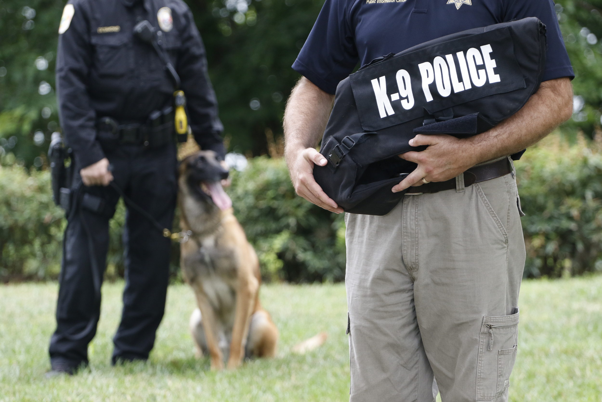 Staff Photo by Dan Henry / The Chattanooga Times Free Press- 7/11/16. Law enforcement officers listen as Tom Edd Wilson, president of the AEGIS Law Enforcement Foundation, speaks during a press conference at the Tennessee Riverpark announcing that twelve new bullet proof vests have been purchased by the Miller Family Foundation for local area K9 law enforcement officers.