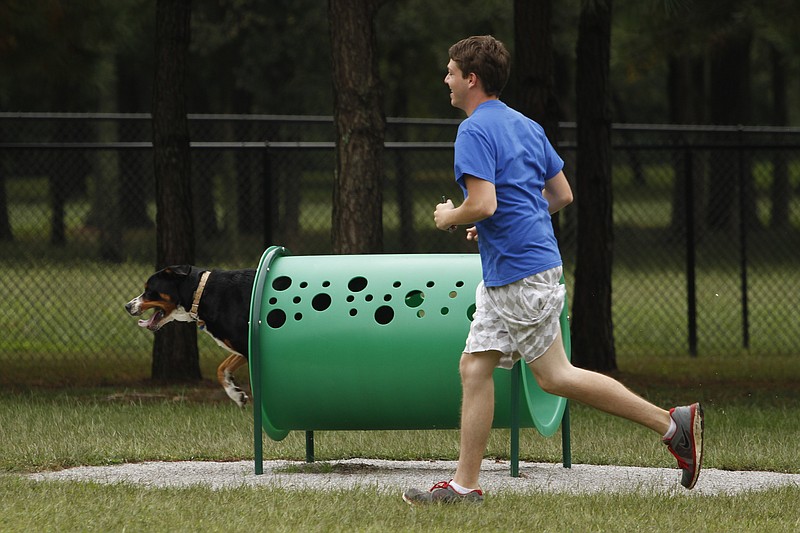 Alex Standefer runs his dog Grace through skills obstacles at the Heritage Dog Park in East Brainerd. The park was funded through the efforts of the Friends of East Brainerd.