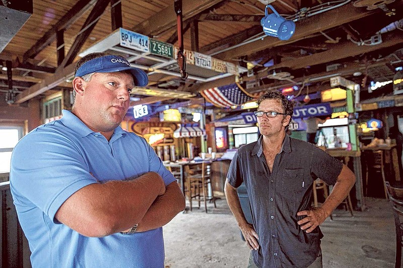 Founder Seth Champion, left, and designer Terry Cannon talk at the new Champy's Famous Fried Chicken location at 6925 Lee Hwy.