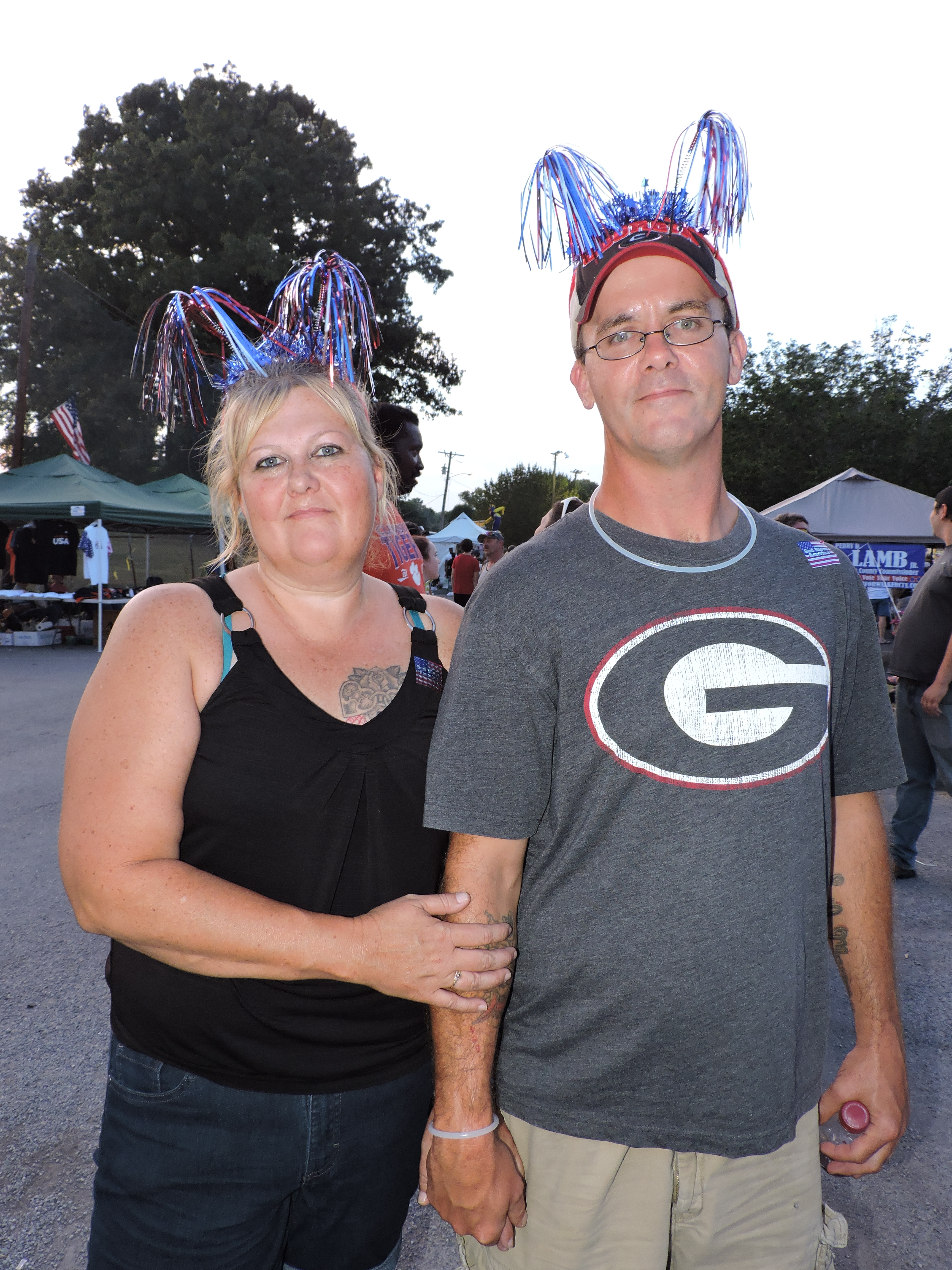 Chickamauga residents Sandra Green, left, and Wesley Dalton wear patriotic streamer hats to show off their patriotic pride.