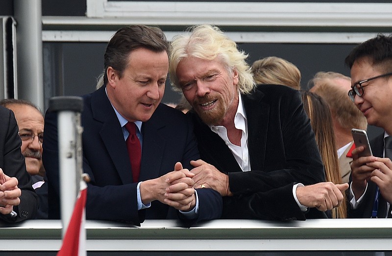 
              Britain's Prime Minister David Cameron, left, and Virgin boss Richard Branson talk at the Farnborough International Airshow in Farnorough, south England, Monday July 11, 2016.  Britain has signed a contract for nine new P-8A Poseidon military aircraft, and Boeing announced Monday a planned expansion for its British operation, as the airshow attracts large international companies to announce their latest plans. (Andrew Matthews / PA via AP)
            