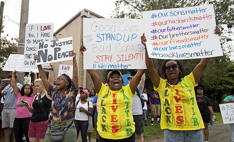 Protesters demonstrate in a residential neighborhood in Baton Rouge, La. on Sunday, July 10, 2016. After an organized protest in downtown Baton Rouge protesters wondered into residential neighborhoods and toward a major highway that caused the police to respond by arresting protesters that refused to disperse.