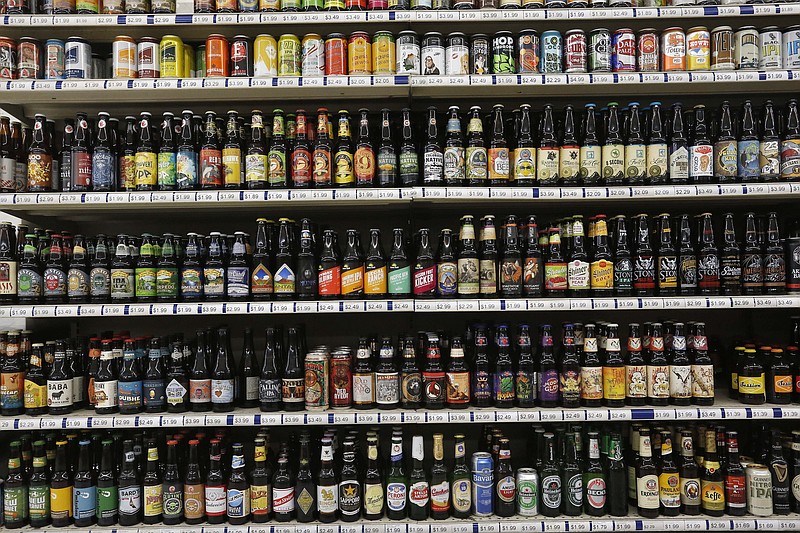 
              FILE - In this June 9, 2016, file photo, a shelf is stocked high with hundreds of varieties of single beers at Liquor Mart in Boulder, Colo. The Beer Institute says it is encouraging its members to start displaying more product information on labels, packaging and websites in a push to provide consumers with more details about ingredients, calories and other nutritional facts about their beverages. (AP Photo/Brennan Linsley, File)
            
