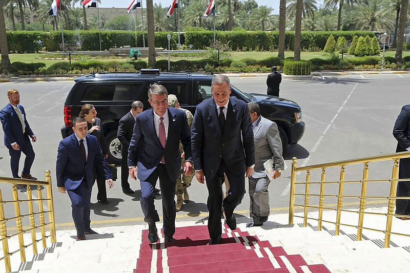 
              Visiting U.S. Defense Secretary Ash Carter, center left, accompanied by the Iraqi Defense Minister Khaled al-Obeidi, center right, arrives to the Ministry of Defense in Baghdad, Iraq, Monday, July 11, 2016. As Carter arrived in Iraq, Monday, he said U.S. and coalition forces will use the newly retaken air base in Qayara as a staging hub as Iraqi security forces move closer to the long-awaited battle to recapture Mosul from Islamic State militants. Carter landed in Baghdad on an unannounced visit and says U.S. advisers are prepared to accompany Iraqi battalions, if needed, as those units move closer to the fight for Mosul. (AP Photo)
            