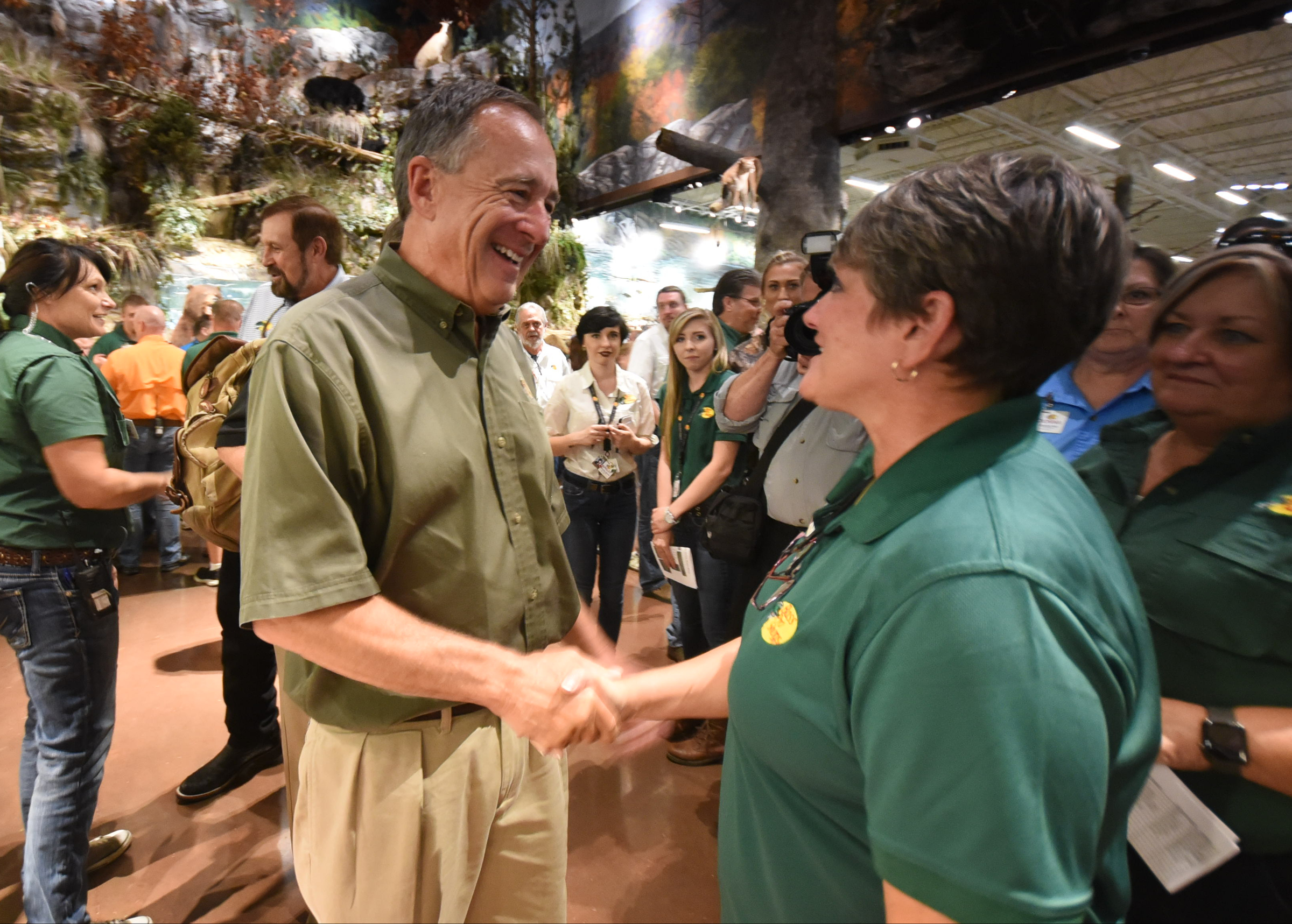 Bass Pro Shops founder Johnny Morris gives well-wishes to footwear employee Hope Sisson in East Ridge just minutes before the long awaited opening of the 85,000-square-foot outdoors retailer late Wednesday.